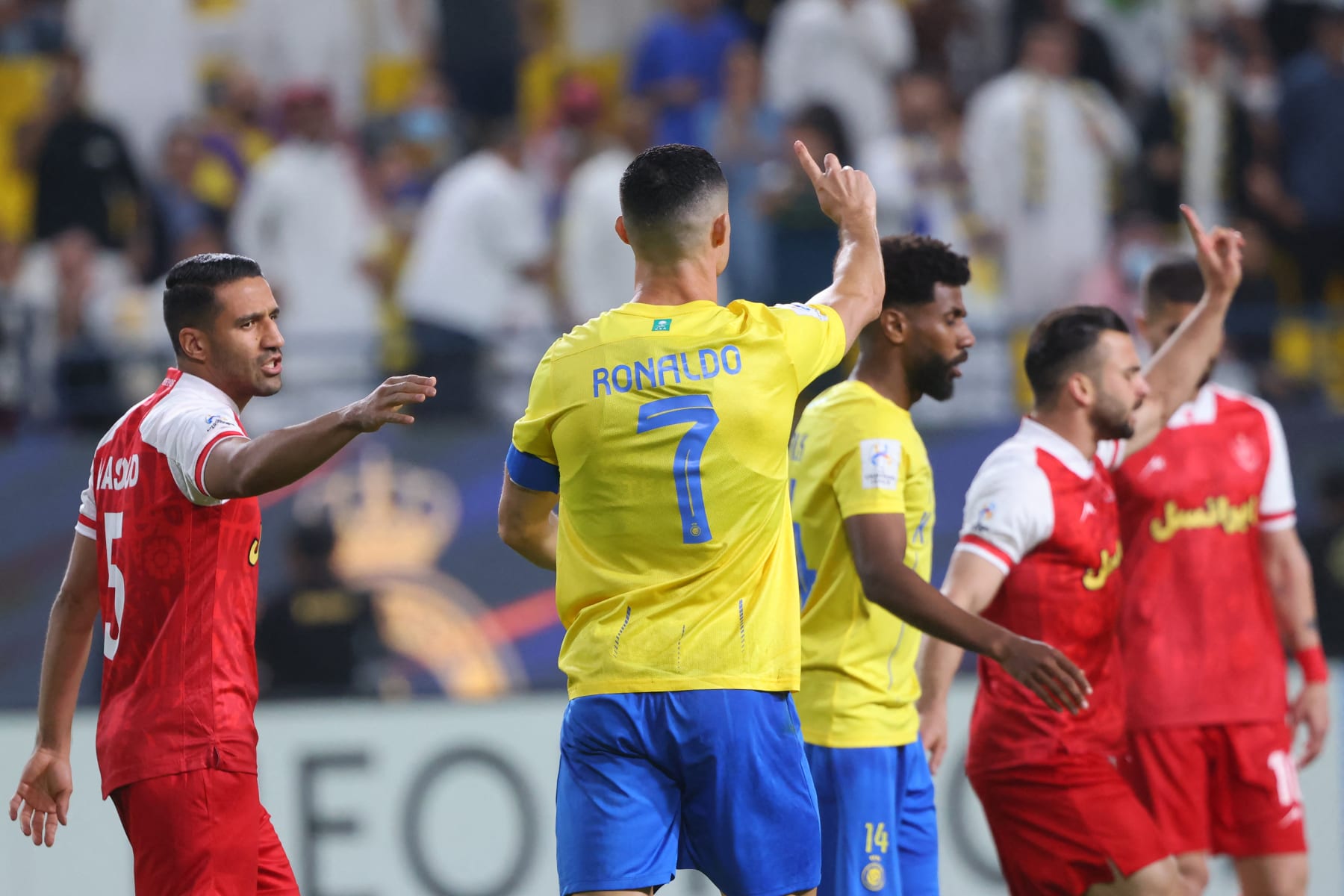 Nassr's Portuguese forward #07 Cristiano Ronaldo tells the referee that there was no foul and no need for a penalty during the AFC Champions League Group E football match between Saudi's al-Nassr and Iran's Persepolis at the Al-Awwal Stadium in Riyadh on November 27, 2023. (Photo by Fayez NURELDINE / AFP) (Photo by FAYEZ NURELDINE/AFP via Getty Images)