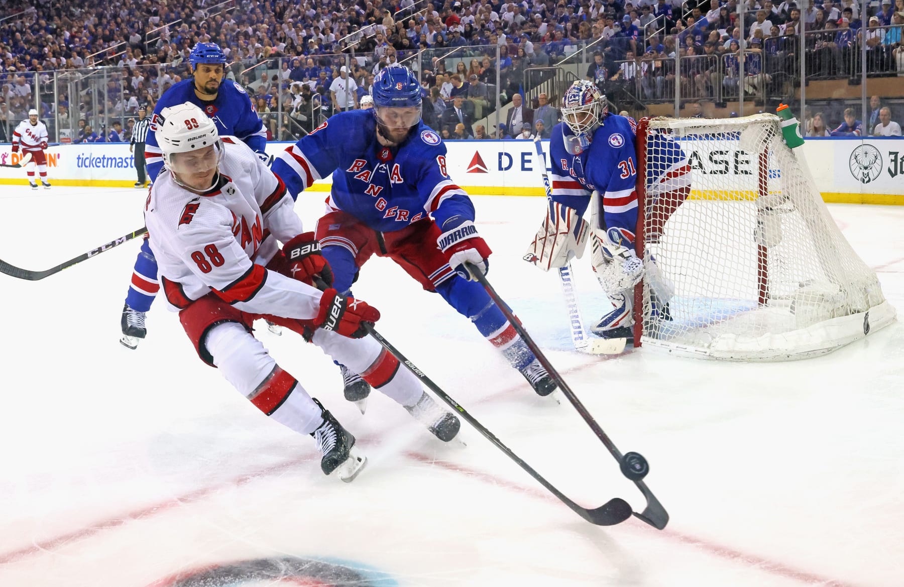Carolina Hurricanes winger Martin NeÄas (left) and New York Rangers defenseman Jacob Trouba battle for the puck. 