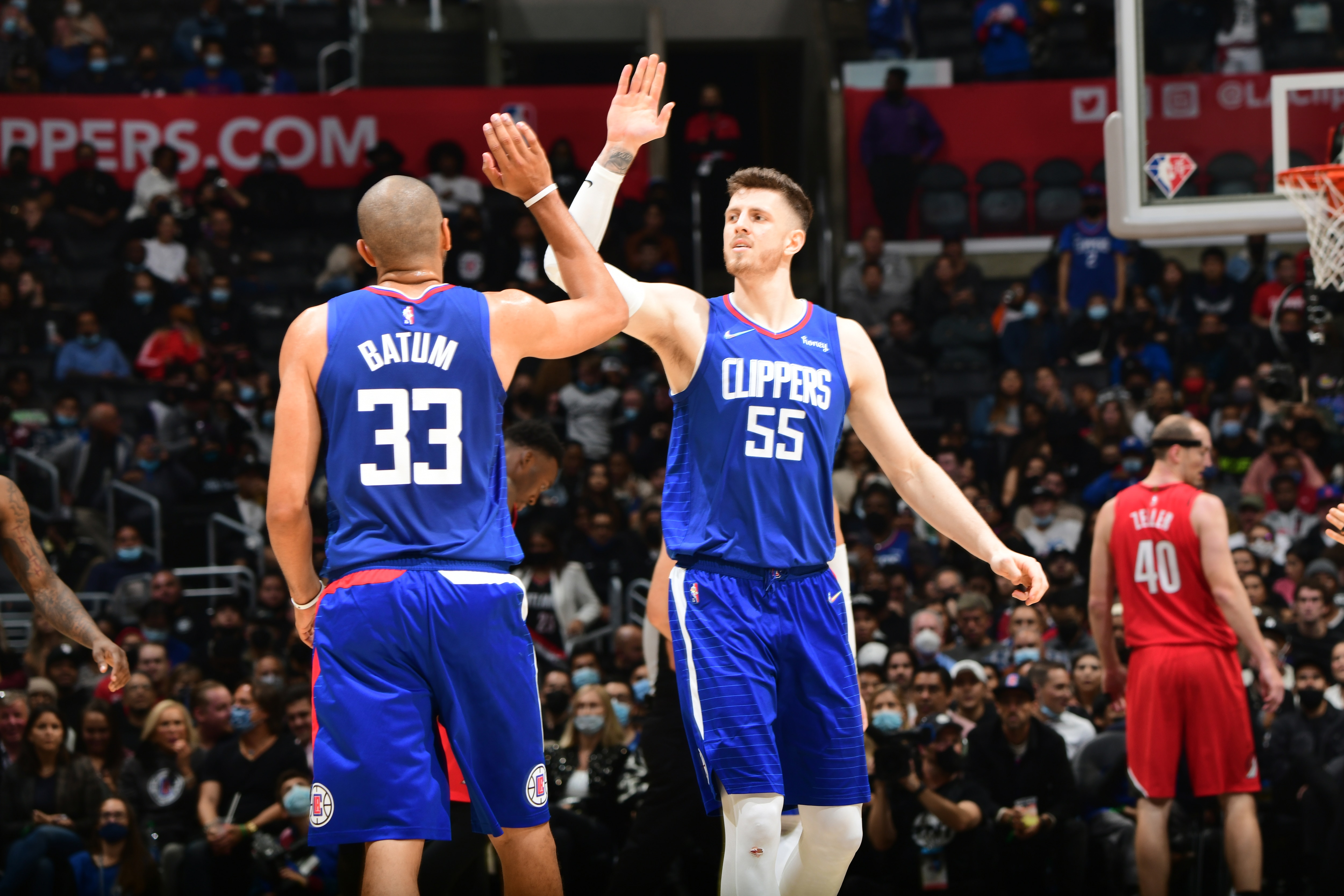 LOS ANGELES, CA - NOVEMBER 9: Nicolas Batum #33 and Isaiah Hartenstein #55 of the LA Clippers hi-five during the game against the Portland Trail Blazers on November 9, 2021 at STAPLES Center in Los Angeles, California. NOTE TO USER: User expressly acknowledges and agrees that, by downloading and/or using this Photograph, user is consenting to the terms and conditions of the Getty Images License Agreement. Mandatory Copyright Notice: Copyright 2021 NBAE (Photo by Adam Pantozzi/NBAE via Getty Images)