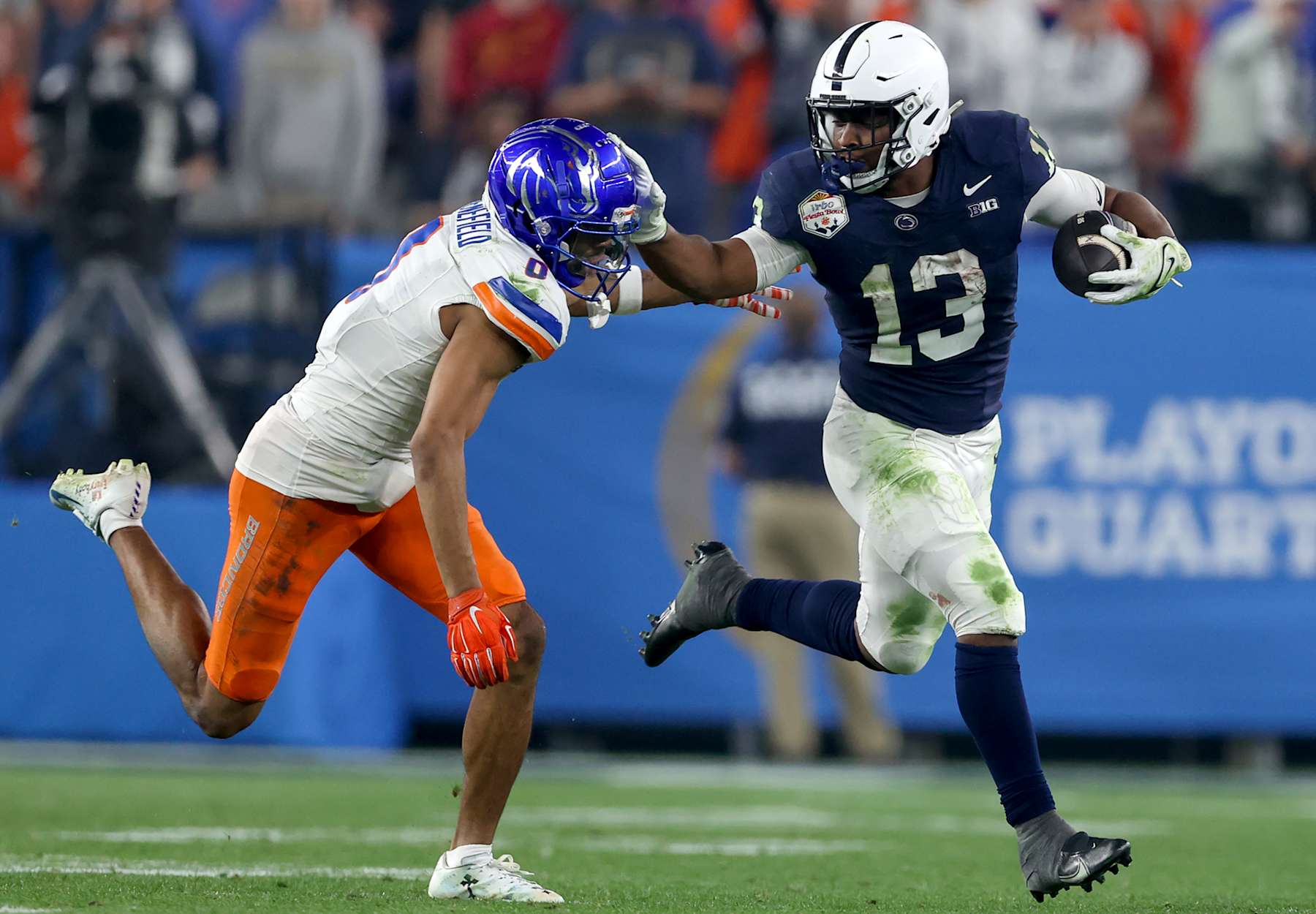 GLENDALE, AZ - DECEMBER 31: Penn State Nittany Lions running back Kaytron Allen (13) tries to elude Boise State Broncos Safety Ty Benefield (0) for a nice gain during the CFP Quarterfinal Vrbo Fiesta Bowl featuring the Penn State Nittany Lions vs. the Boise State Broncos on December 31, 2024 at State Farm Stadium in Glendale, Arizona. (Photo by Steve Nurenberg/Icon Sportswire via Getty Images)