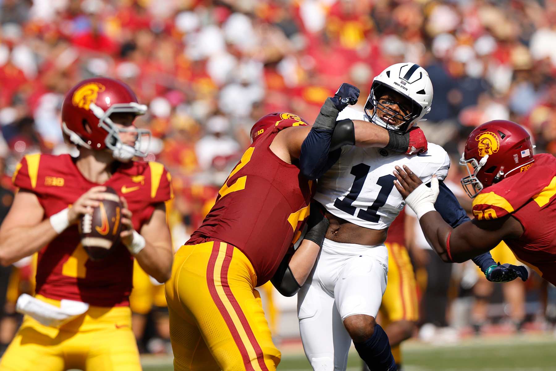 LOS ANGELES, CALIFORNIA - OCTOBER 12: Abdul Carter #11 of the Penn State Nittany Lions is stopped by Elijah Paige #72  and Emmanuel Pregnon #70 of the USC Trojans as he tries to apply pressure during the second quarter at United Airlines Field at the Los Angeles Memorial Coliseum on October 12, 2024 in Los Angeles, California. (Photo by Kevork Djansezian/Getty Images)