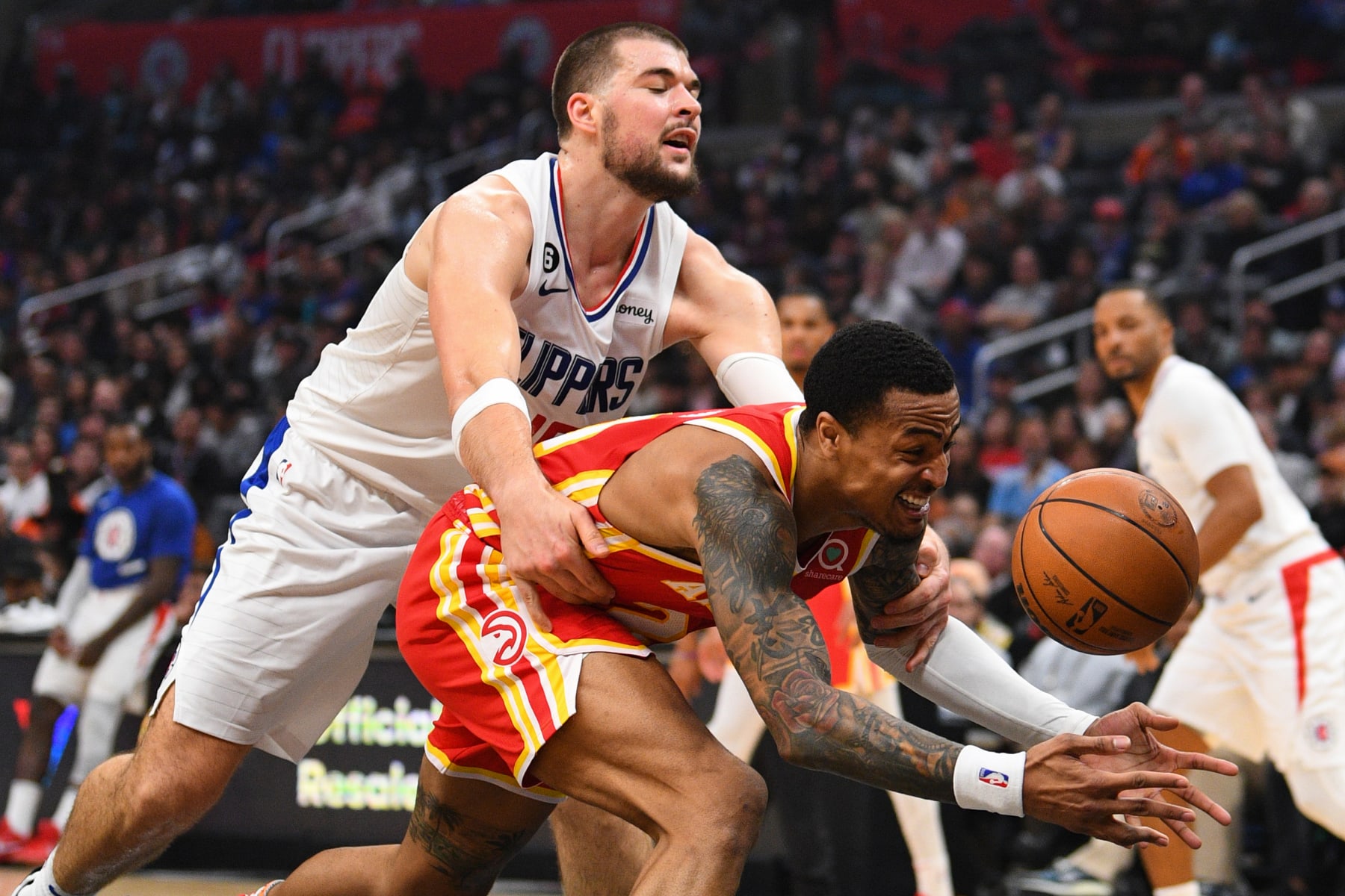 LOS ANGELES, CA - JANUARY 08: Los Angeles Clippers Center Ivica Zubac (40) fouls Atlanta Hawks Forward John Collins (20) during a NBA game between the Atlanta Hawks and the Los Angeles Clippers on January 8, 2023 at Crypto.com Arena in Los Angeles, CA. (Photo by Brian Rothmuller/Icon Sportswire via Getty Images)
