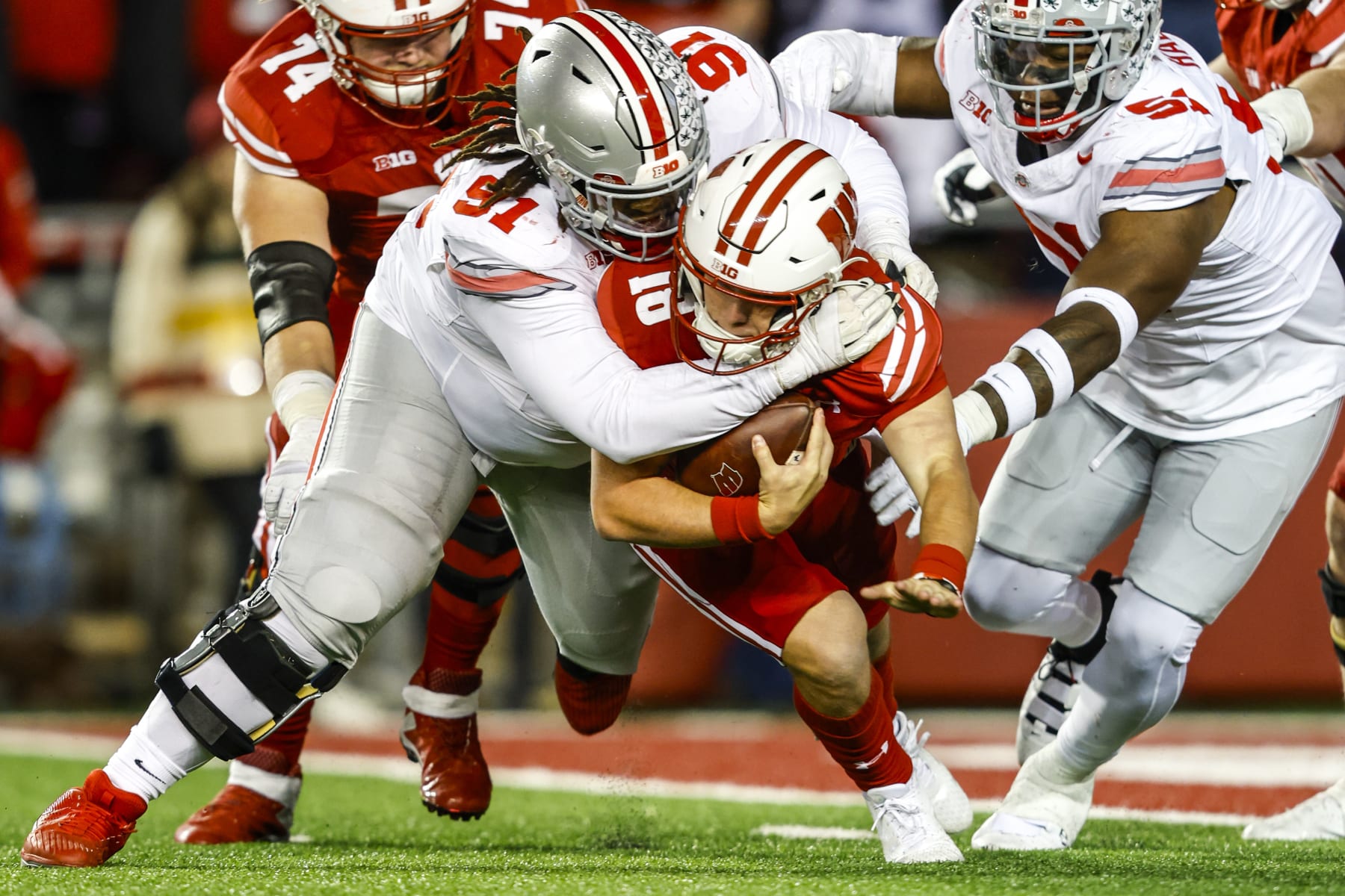 MADISON, WI - OCTOBER 28: Wisconsin quarterback Braedyn Locke (18) is sacked by Ohio State defensive tackle Tyleik Williams (91) near the goal line during a college football game between the University of Wisconsin Badgers and the Ohio State University Buckeyes on October 28, 2023 at Camp Randall Stadium in Madison, WI. (Photo by Lawrence Iles/Icon Sportswire via Getty Images)