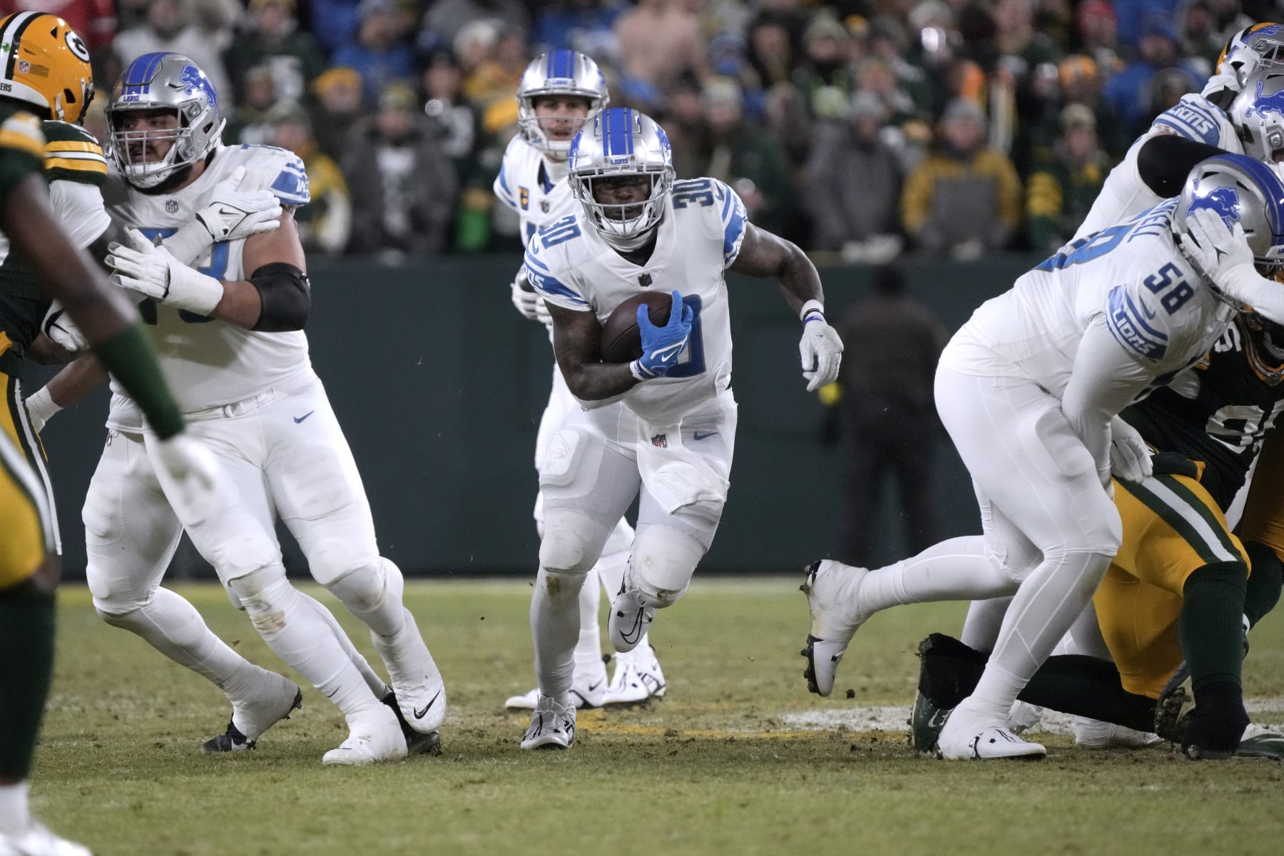 Detroit Lions running back Jamaal Williams runs with the ball during the first half of an NFL football game against the Green Bay Packers Sunday, Jan. 8, 2023, in Green Bay, Wis. (AP Photo/Morry Gash)