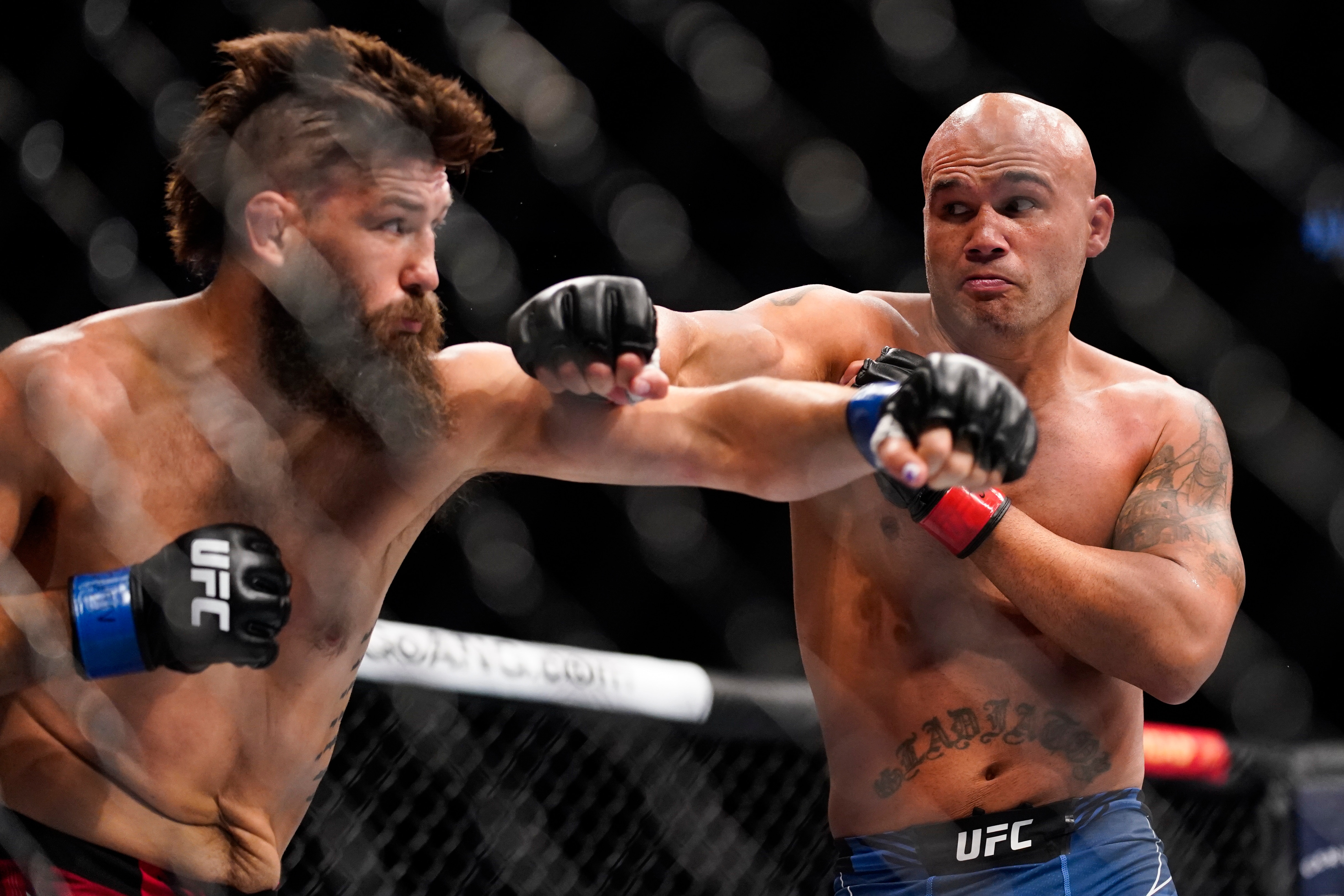 Bryan Barberena, left, fights Robbie Lawler in a welterweight bout during the UFC 276 mixed martial arts event Saturday, July 2, 2022, in Las Vegas. (AP Photo/John Locher)