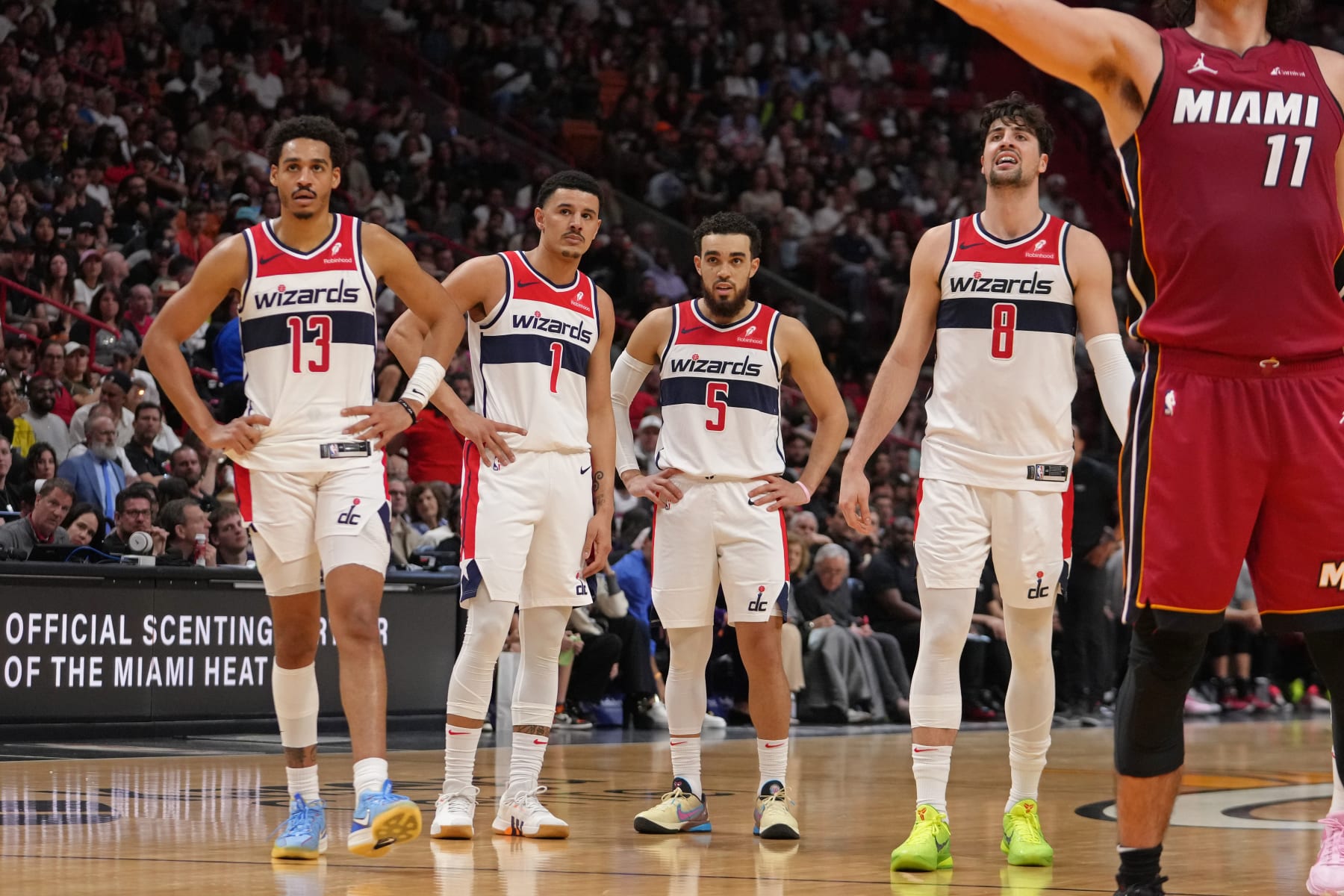 MIAMI, FL - MARCH 10: Jordan Poole #13, Johnny Davis #1, Tyus Jones #5, and Deni Avdija #8 of the Washington Wizards look on during the game against the Miami Heat on March 10, 2024 at Kaseya Center in Miami, Florida. NOTE TO USER: User expressly acknowledges and agrees that, by downloading and or using this Photograph, user is consenting to the terms and conditions of the Getty Images License Agreement. Mandatory Copyright Notice: Copyright 2024 NBAE (Photo by Eric Espada/NBAE via Getty Images)