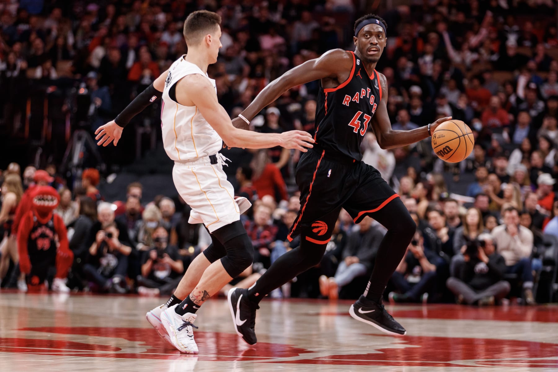 TORONTO, ON - MARCH 28: Pascal Siakam #43 of the Toronto Raptors dribbles against Tyler Herro #14 of the Miami Heat during the second half of their NBA game at Scotiabank Arena on March 28, 2023 in Toronto, Canada. NOTE TO USER: User expressly acknowledges and agrees that, by downloading and or using this photograph, User is consenting to the terms and conditions of the Getty Images License Agreement. (Photo by Cole Burston/Getty Images)