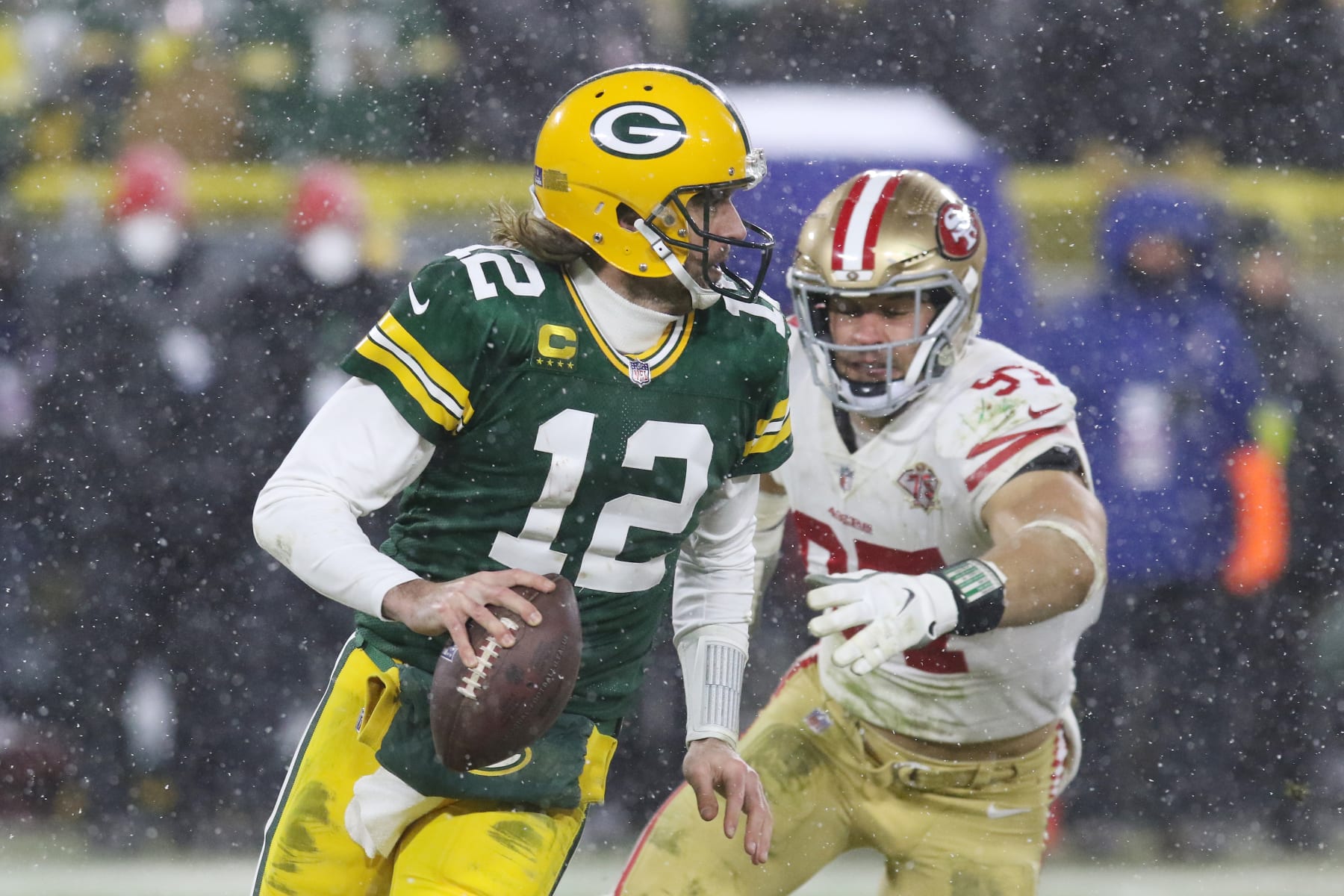 GREEN BAY, WI - JANUARY 22: San Francisco 49ers defensive end Nick Bosa (97) chases Green Bay Packers quarterback Aaron Rodgers (12) during the NFC Divisional playoff game between the Green Bay Packers and the San Francisco 49ers at Lambeau Field on January 22, 2022, in Green Bay, WI. (Photo by Larry Radloff/Icon Sportswire via Getty Images)