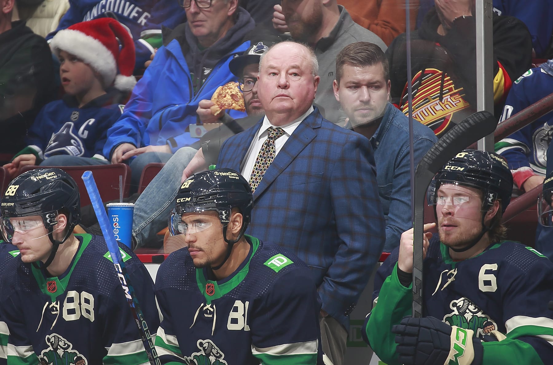 VANCOUVER, CANADA - DECEMBER 10: Head coach Bruce Boudreau of the Vancouver Canucks looks on from the bench during their NHL game against the Minnesota Wild at Rogers Arena December 10, 2022 in Vancouver, British Columbia, Canada.  (Photo by Jeff Vinnick/NHLI via Getty Images)