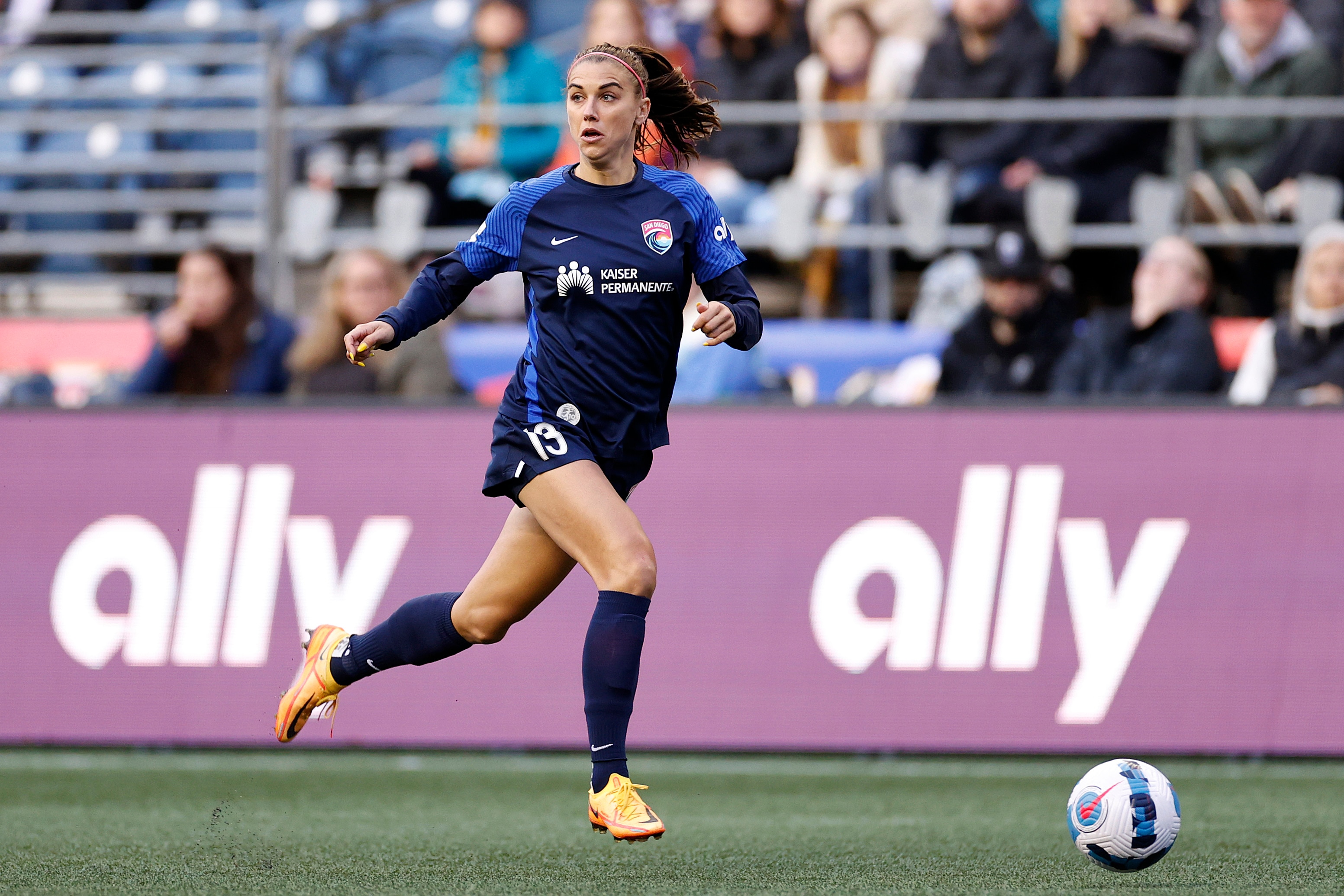 SEATTLE, WASHINGTON - APRIL 14: Alex Morgan #13 of San Diego Wave FC  controls the ball during the first half against the OL Reign at Lumen Field on April 14, 2022 in Seattle, Washington. (Photo by Steph Chambers/Getty Images)