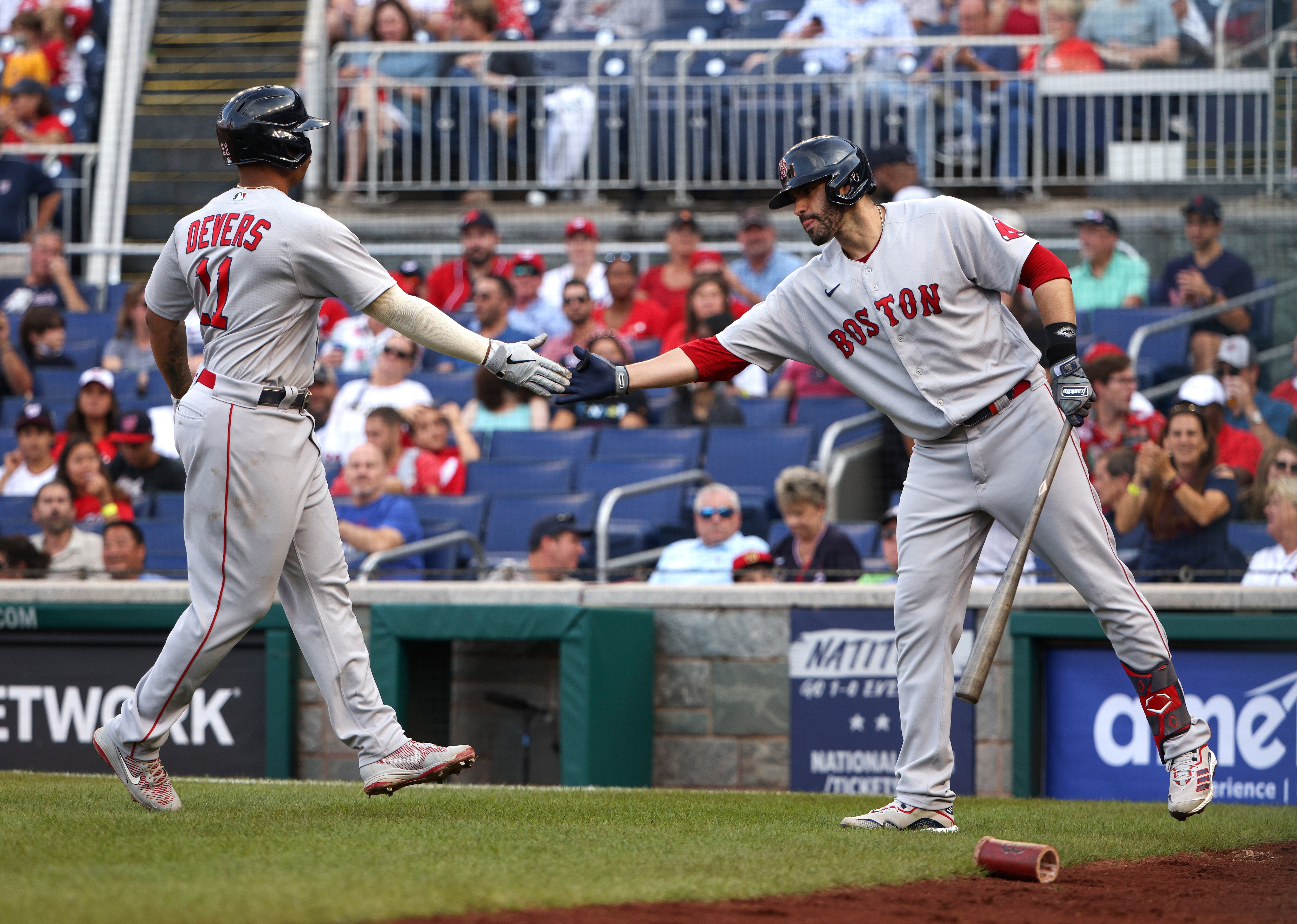 WASHINGTON, DC - OCTOBER 02: Rafael Devers #11 of the Boston Red Sox celebrates with teammate Lane Thomas #28 after hitting a solo home run against the Washington Nationals in the fourth inning at Nationals Park on October 02, 2021 in Washington, DC. (Photo by Kevin Dietsch/Getty Images)
