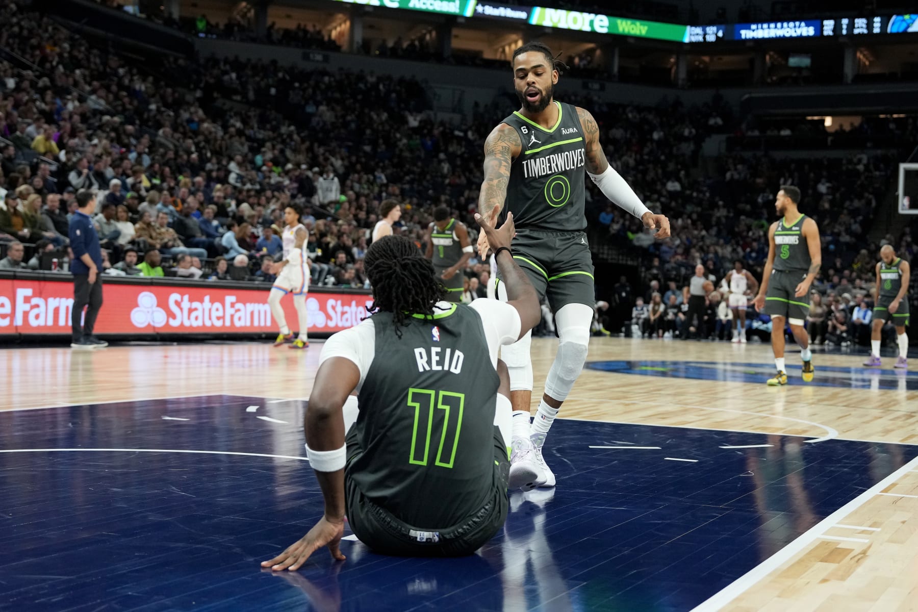 MINNEAPOLIS, MN -  DECEMBER 3: D'Angelo Russell #0 helps up teammate Naz Reid #11 of the Minnesota Timberwolves during the game against the Oklahoma City Thunder on December 3, 2022 at Target Center in Minneapolis, Minnesota. NOTE TO USER: User expressly acknowledges and agrees that, by downloading and or using this Photograph, user is consenting to the terms and conditions of the Getty Images License Agreement. Mandatory Copyright Notice: Copyright 2022 NBAE (Photo by Jordan Johnson/NBAE via Getty Images)