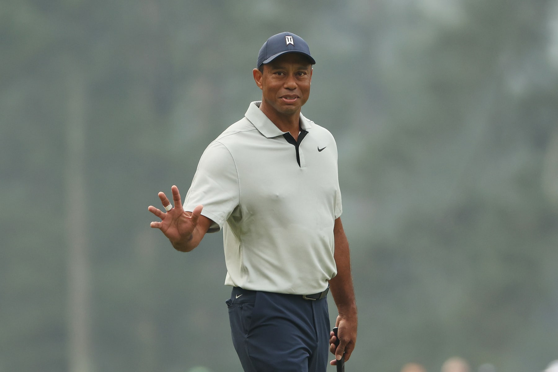 AUGUSTA, GEORGIA - APRIL 04: Tiger Woods of the United States waves on the third green during a practice round prior to the 2023 Masters Tournament at Augusta National Golf Club on April 04, 2023 in Augusta, Georgia. (Photo by Patrick Smith/Getty Images)