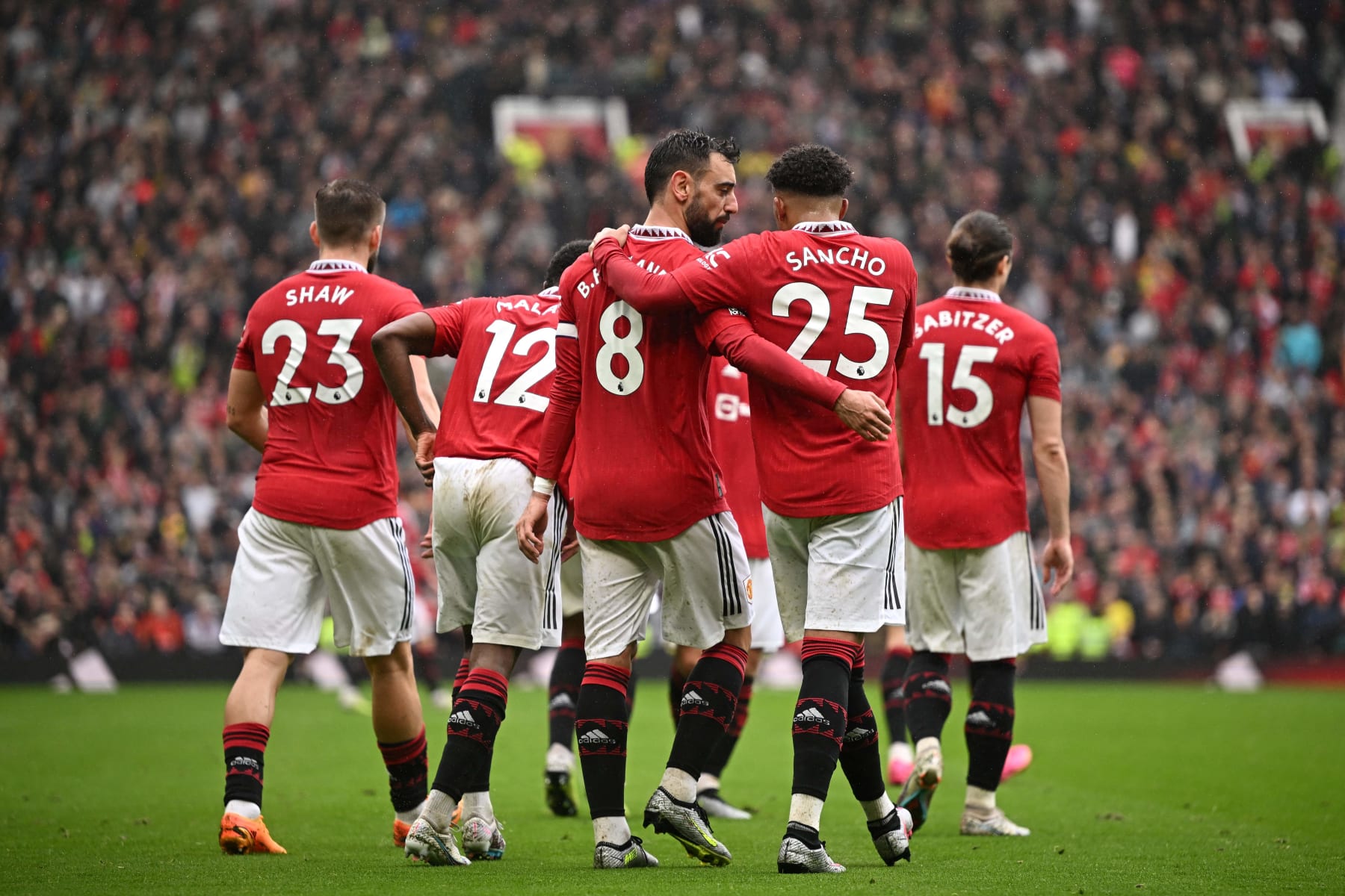Manchester United's Portuguese midfielder Bruno Fernandes celebrates with Manchester United's English striker Jadon Sancho after scoring his team first goal during the English Premier League football match between Manchester United and Aston Villa at Old Trafford in Manchester, north west England, on April 30, 2023. (Photo by Oli SCARFF / AFP) / RESTRICTED TO EDITORIAL USE. No use with unauthorized audio, video, data, fixture lists, club/league logos or 'live' services. Online in-match use limited to 120 images. An additional 40 images may be used in extra time. No video emulation. Social media in-match use limited to 120 images. An additional 40 images may be used in extra time. No use in betting publications, games or single club/league/player publications. /  (Photo by OLI SCARFF/AFP via Getty Images)