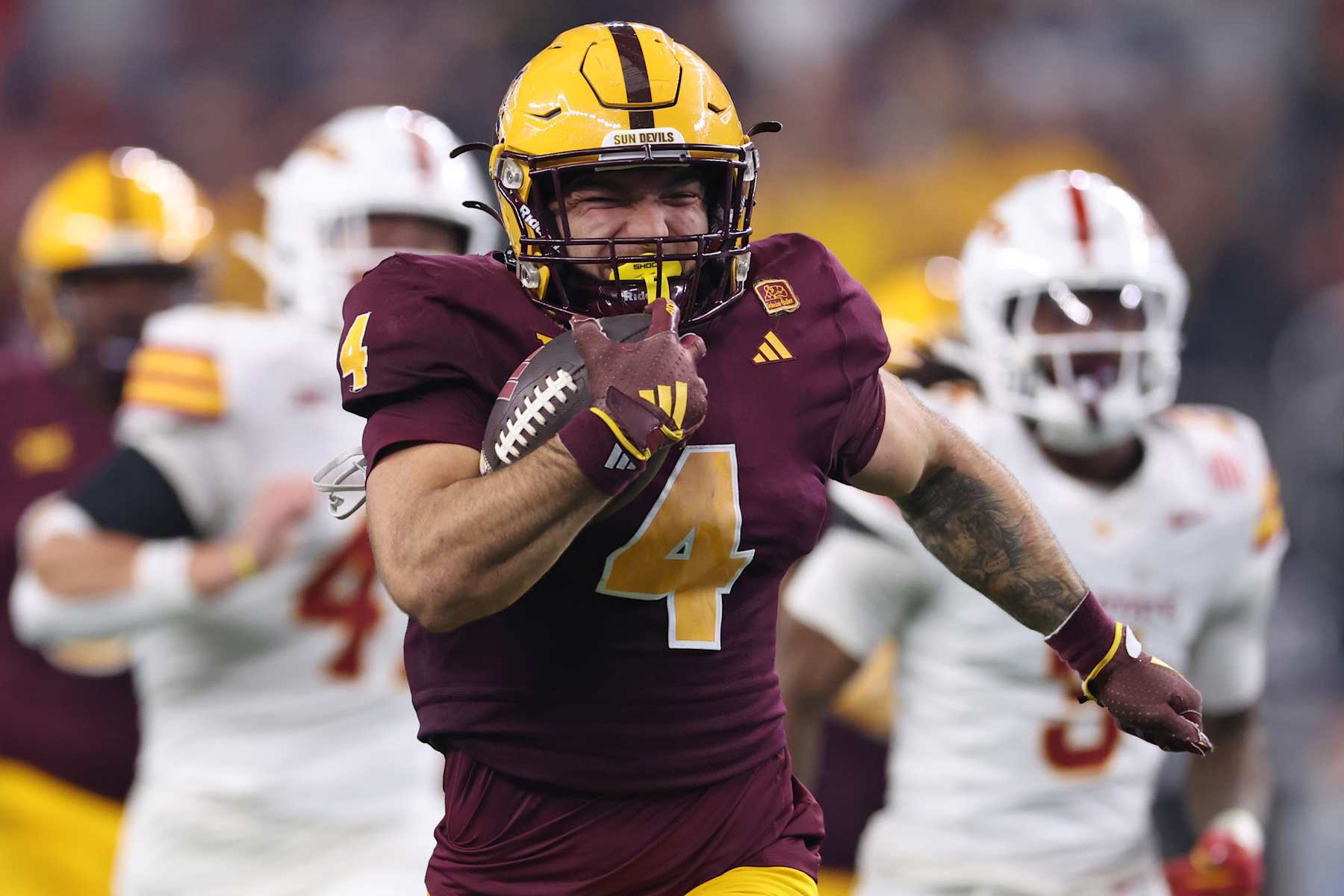 ARLINGTON, TEXAS - DECEMBER 07: Cam Skattebo #4 of the Arizona State Sun Devils carries the ball against the Iowa State Cyclones during the second quarter of the Big 12 Championship game at AT&T Stadium on December 07, 2024 in Arlington, Texas. (Photo by Sam Hodde/Getty Images)