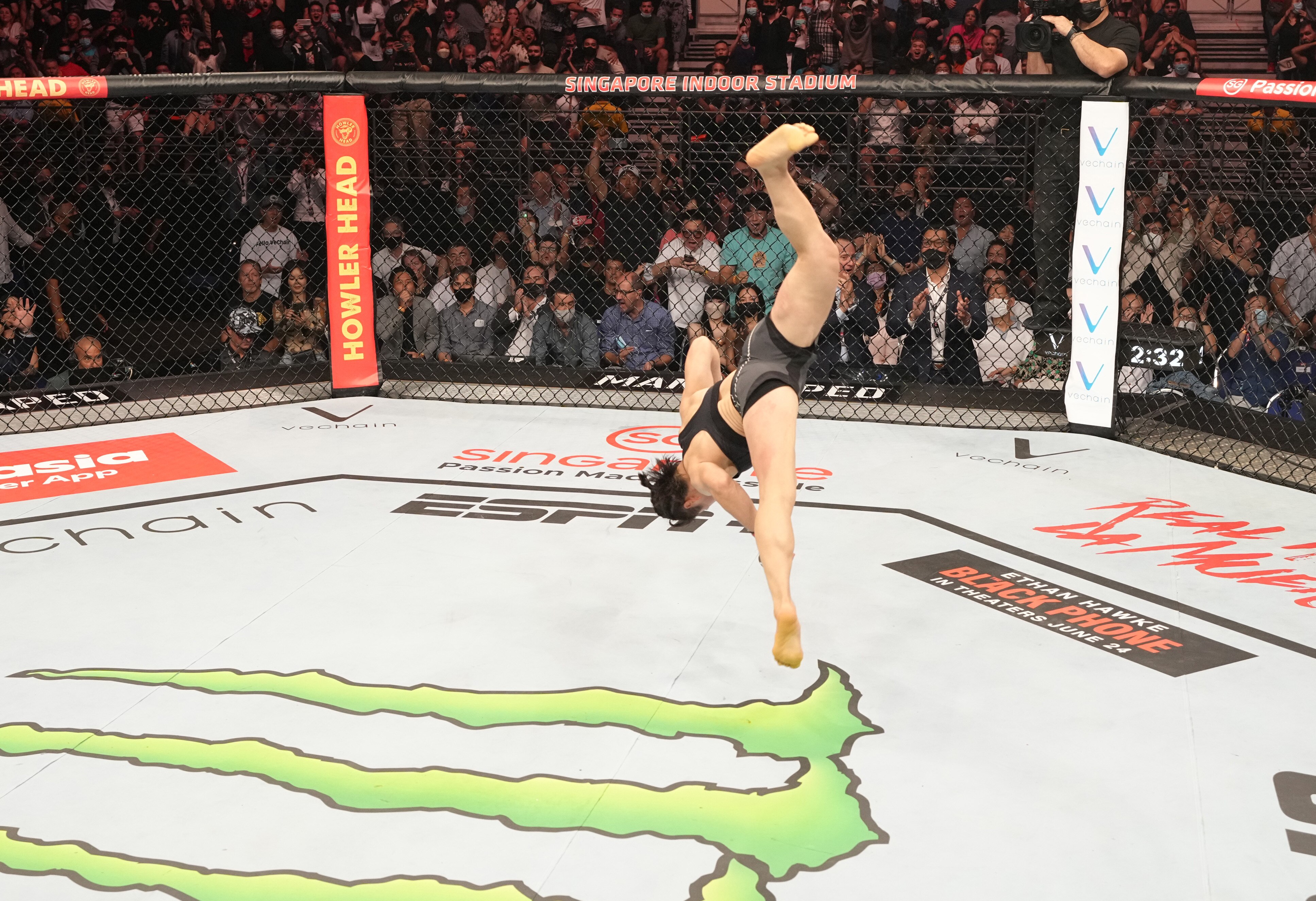 SINGAPORE, SINGAPORE - JUNE 12: Zhang Weili of China celebrates after her knockout victory over Joanna Jedrzejczyk of Poland in a flyweight fight during the UFC 275 event at Singapore Indoor Stadium on June 12, 2022 in Singapore. (Photo by Jeff Bottari/Zuffa LLC)