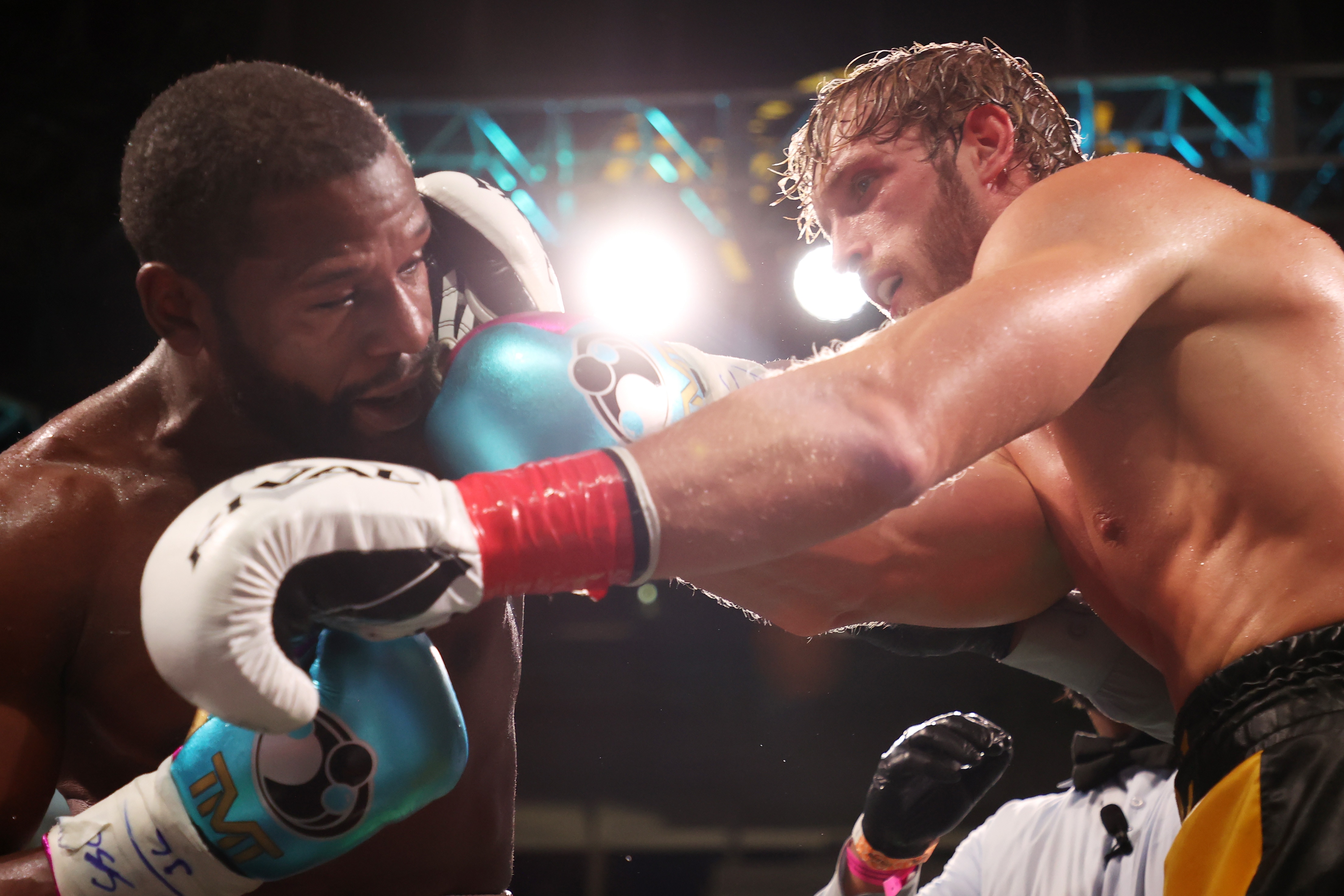 MIAMI GARDENS, FLORIDA - JUNE 06: Floyd Mayweather (L) exchanges blows with Logan Paul during their contracted exhibition boxing match at Hard Rock Stadium on June 06, 2021 in Miami Gardens, Florida. (Photo by Cliff Hawkins/Getty Images)