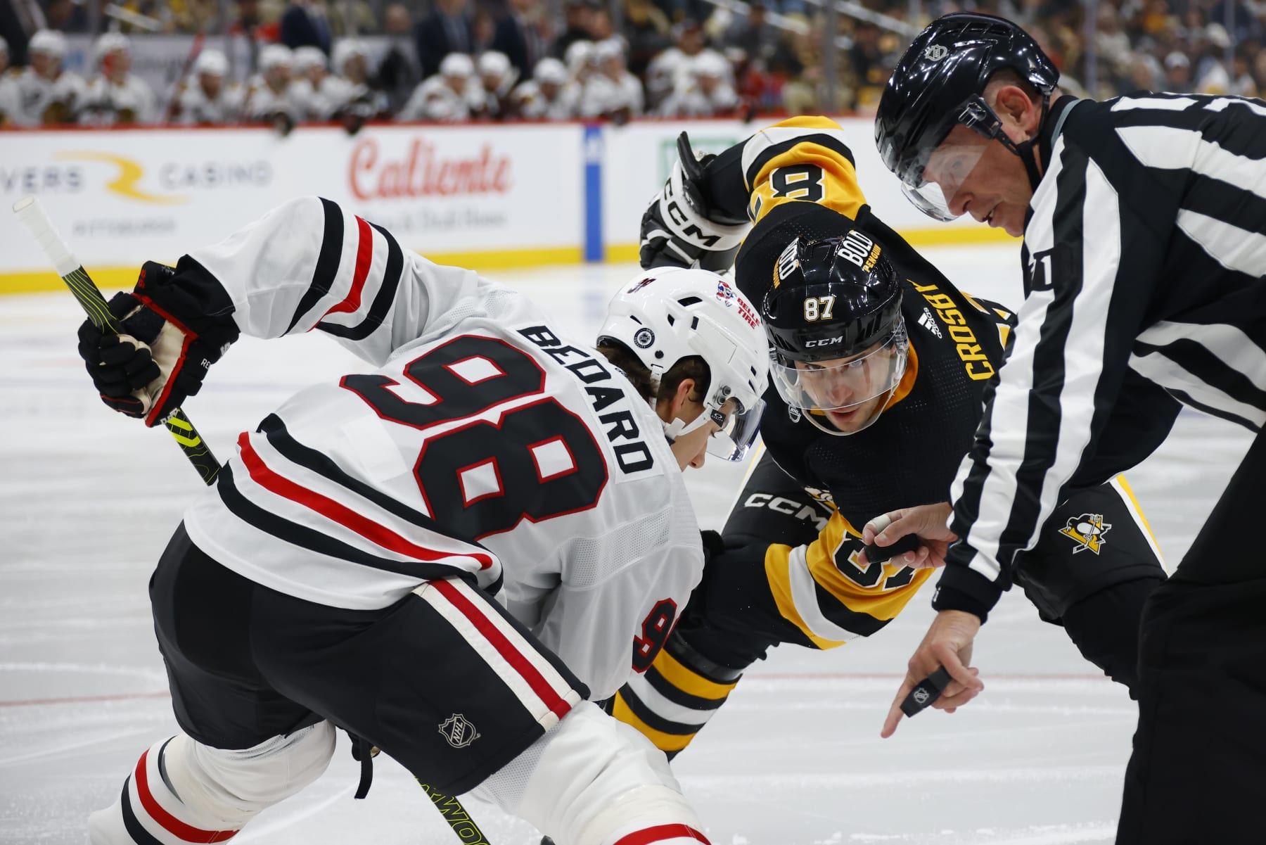 PITTSBURGH, PENNSYLVANIA - OCTOBER 10: Connor Bedard #98 of the Chicago Blackhawks faces off against Sidney Crosby #87 of the Pittsburgh Penguins during the second period at PPG PAINTS Arena on October 10, 2023 in Pittsburgh, Pennsylvania. (Photo by Bruce Bennett/Getty Images)