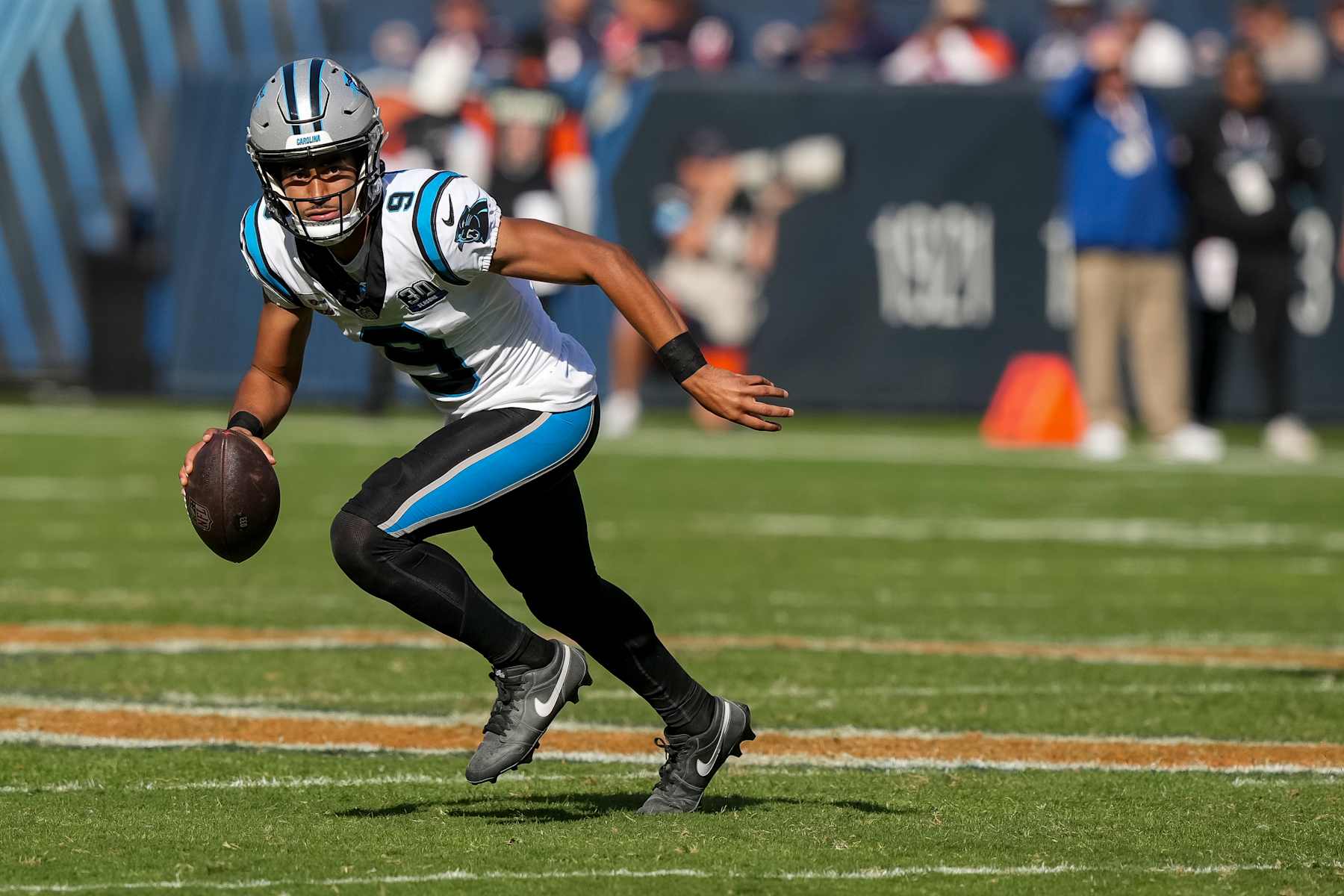CHICAGO, ILLINOIS - OCTOBER 6: Quarterback Bryce Young #9 of the Carolina Panthers scrambles out of the pocket during the fourth quarter of an NFL football game against the Chicago Bears, at Soldier Field on October 6, 2024 in Chicago, Illinois. (Photo by Todd Rosenberg/Getty Images)