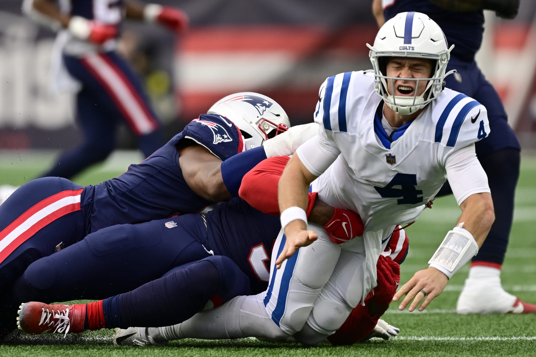 FOXBOROUGH, MASSACHUSETTS - NOVEMBER 06: Sam Ehlinger #4 of the Indianapolis Colts gets tackled by Matthew Judon #9 of the New England Patriots in the second quarter at Gillette Stadium on November 06, 2022 in Foxborough, Massachusetts. (Photo by Billie Weiss/Getty Images)