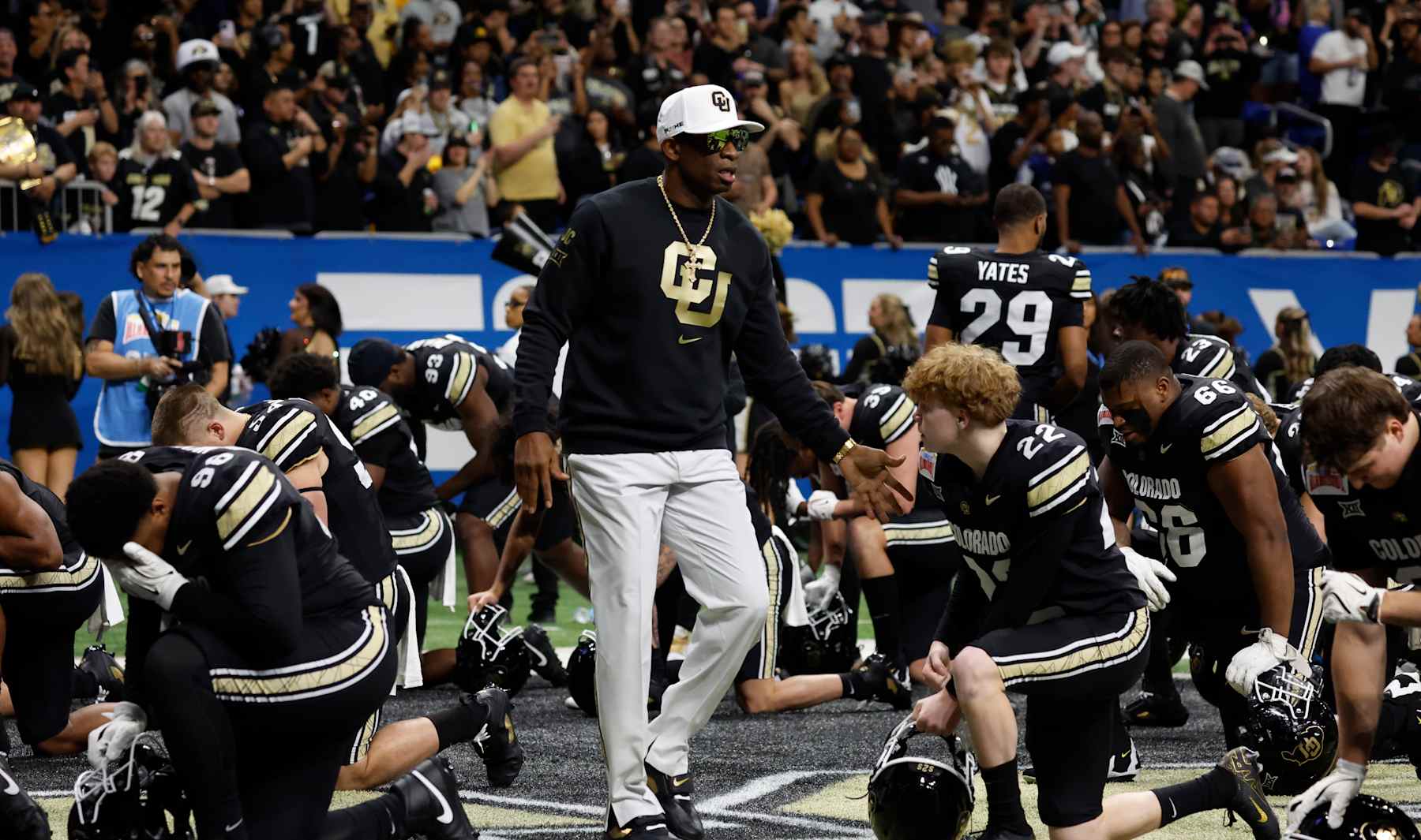 SAN ANTONIO, TX - DECEMBER 28:  Deion Sanders head coach of the Colorado Buffaloes greets his team before the start of their game against the BYU Cougars in the Valero Alamo Bowl at Alamodome on December 28, 2024 in San Antonio, Texas. (Photo by Ronald Cortes/Getty Images)