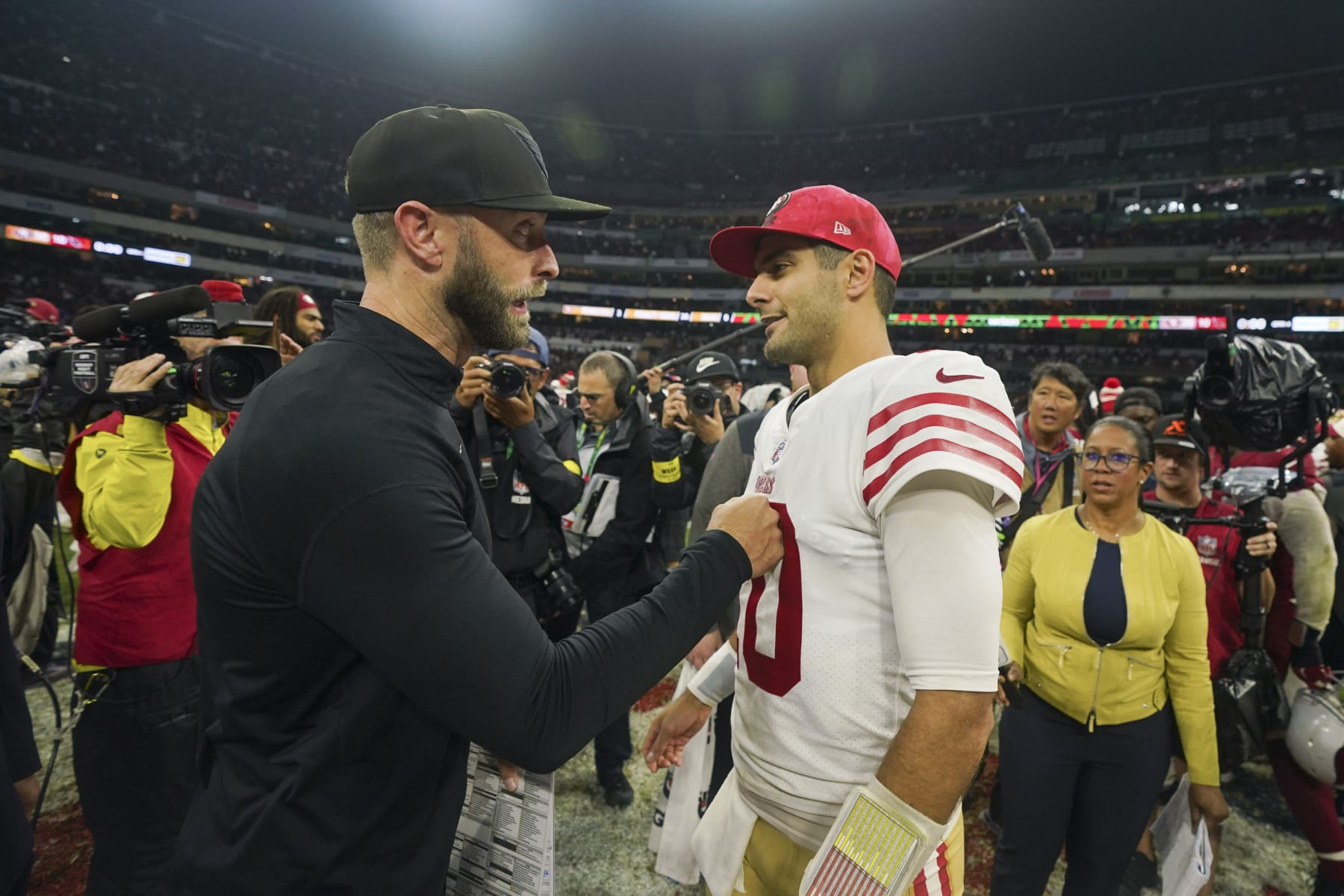 San Francisco 49ers quarterback Jimmy Garoppolo greets Arizona Cardinals head coach Kliff Kingsbury after the 49ers defeated the Cardinals 38-10 in an NFL football game Monday, Nov. 21, 2022, in Mexico City. (AP Photo/Fernando Llano)