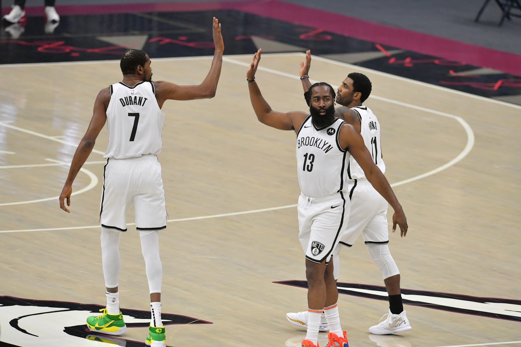 CLEVELAND, OHIO - JANUARY 20: Kevin Durant #7 James Harden #13 and Kyrie Irving #11 of the Brooklyn Nets celebrate during the first quarter against the Cleveland Cavaliers at Rocket Mortgage Fieldhouse on January 20, 2021 in Cleveland, Ohio. NOTE TO USER: User expressly acknowledges and agrees that, by downloading and/or using this photograph, user is consenting to the terms and conditions of the Getty Images License Agreement. (Photo by Jason Miller/Getty Images)