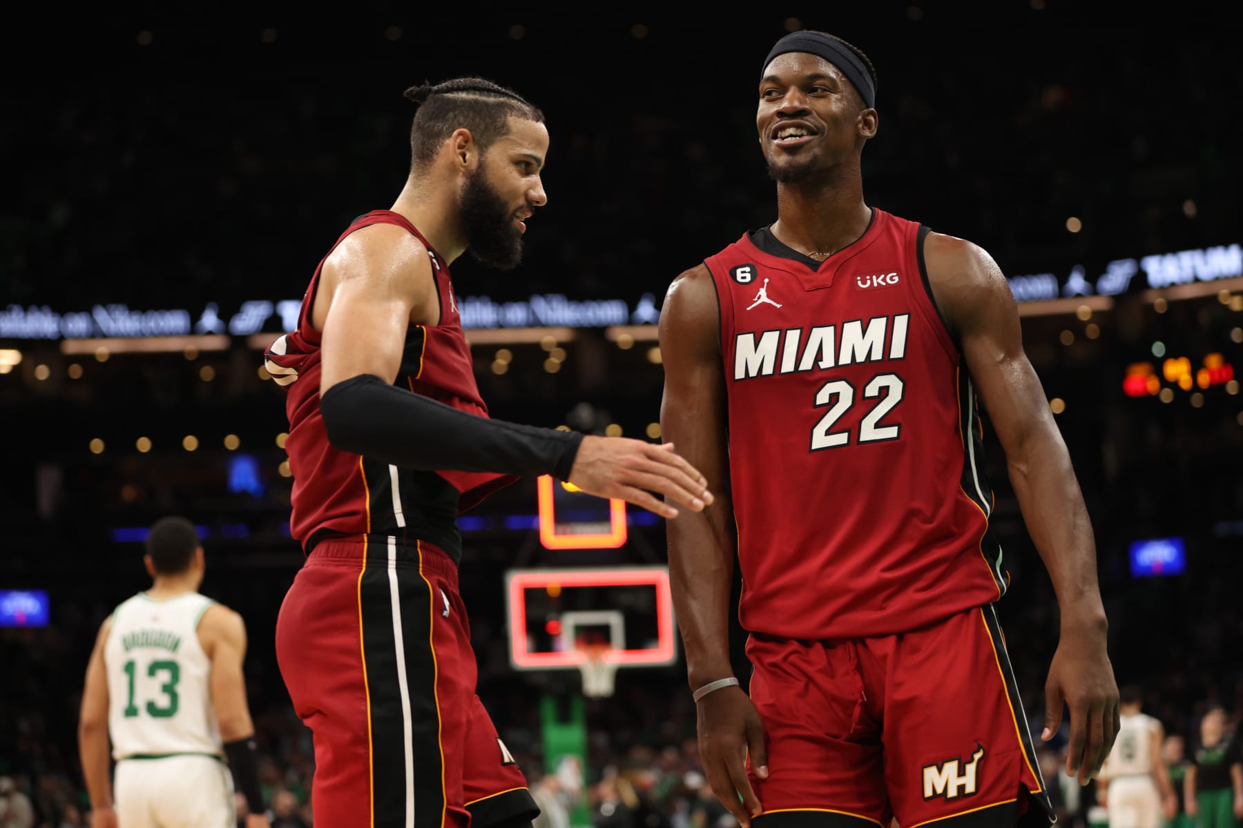 BOSTON, MASSACHUSETTS - MAY 19: Caleb Martin #16 of the Miami Heat high fives Jimmy Butler #22 of the Miami Heat during the fourth quarter against the Boston Celtics in game two of the Eastern Conference Finals at TD Garden on May 19, 2023 in Boston, Massachusetts. NOTE TO USER: User expressly acknowledges and agrees that, by downloading and or using this photograph, User is consenting to the terms and conditions of the Getty Images License Agreement. (Photo by Adam Glanzman/Getty Images)
