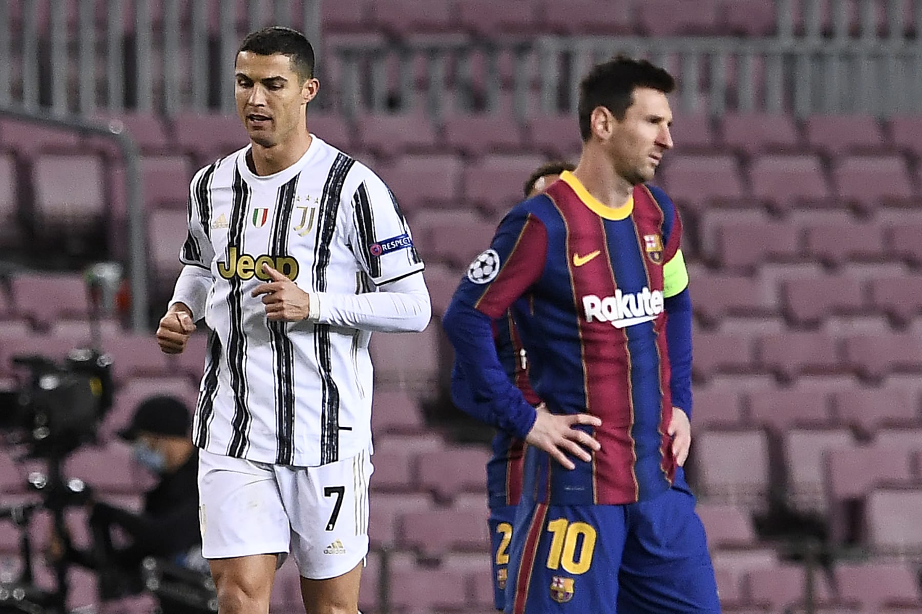 Juventus' Portuguese forward Cristiano Ronaldo (L) walks past Barcelona's Argentinian forward Lionel Messi during the UEFA Champions League group G football match between Barcelona and Juventus at the Camp Nou stadium in Barcelona on December 8, 2020. (Photo by Josep LAGO / AFP) (Photo by JOSEP LAGO/AFP via Getty Images)