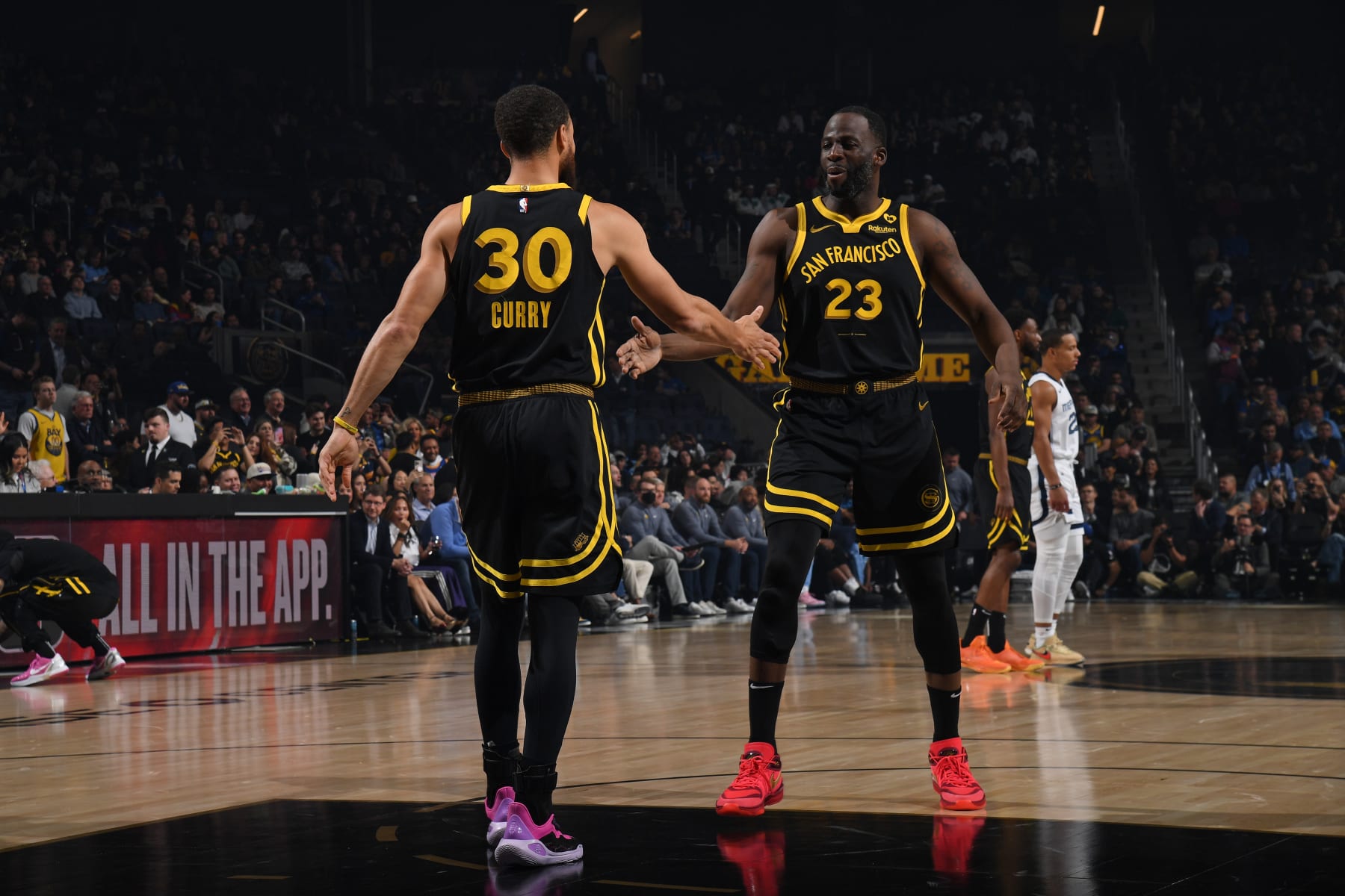 SAN FRANCISCO, CA - MARCH 20: Stephen Curry #30 and Draymond Green #23 of the Golden State Warriors high five during the game against the Memphis Grizzlies on March 20, 2024 at Chase Center in San Francisco, California. NOTE TO USER: User expressly acknowledges and agrees that, by downloading and or using this photograph, user is consenting to the terms and conditions of Getty Images License Agreement. Mandatory Copyright Notice: Copyright 2024 NBAE (Photo by Noah Graham/NBAE via Getty Images)
