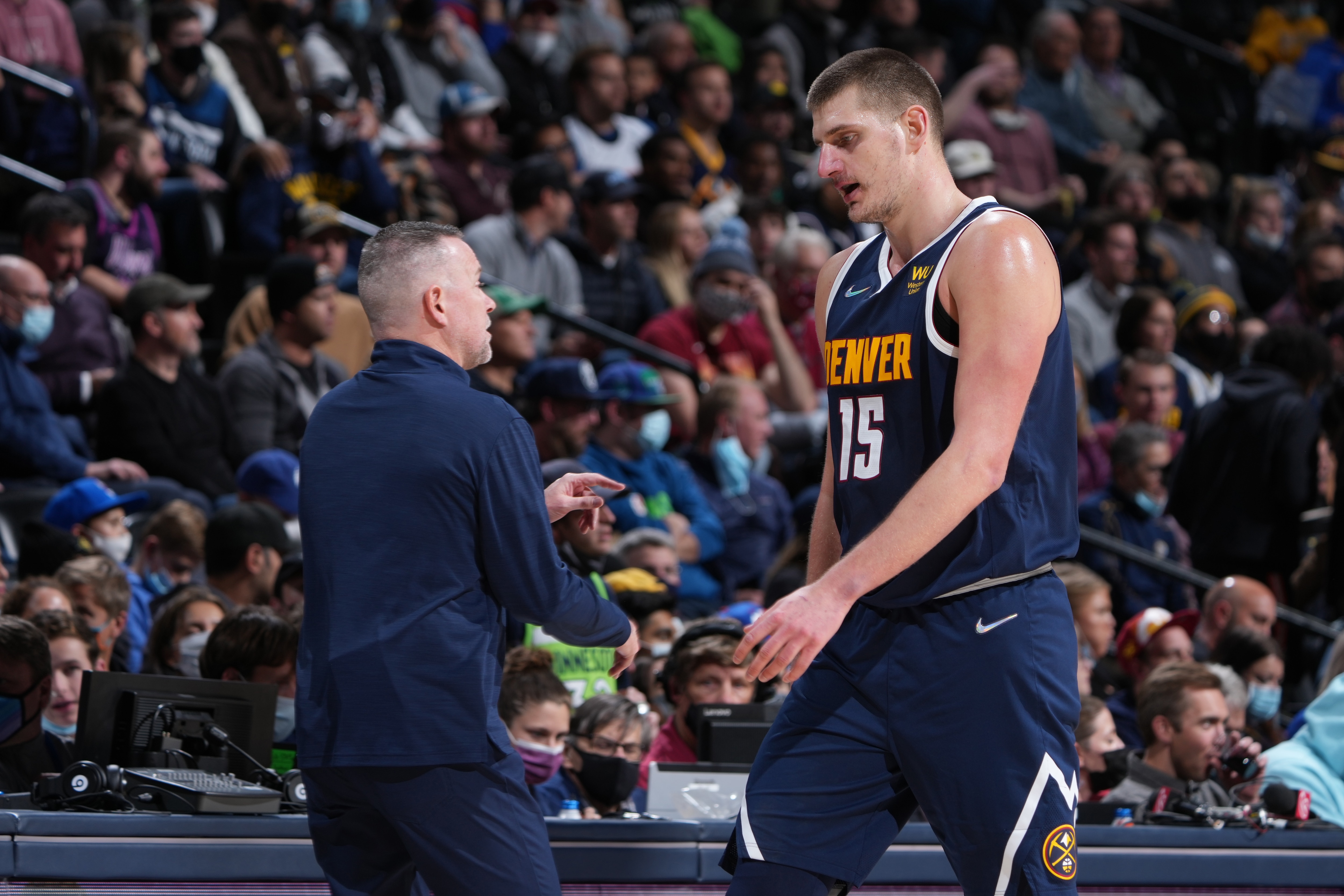 DENVER, CO - DECEMBER 15: Head Coach Michael Malone of the Denver Nuggets talks with Nikola Jokic #15 during the game against the Minnesota Timberwolves on December 15, 2021 at the Ball Arena in Denver, Colorado. NOTE TO USER: User expressly acknowledges and agrees that, by downloading and/or using this Photograph, user is consenting to the terms and conditions of the Getty Images License Agreement. Mandatory Copyright Notice: Copyright 2021 NBAE (Photo by Garrett Ellwood/NBAE via Getty Images)