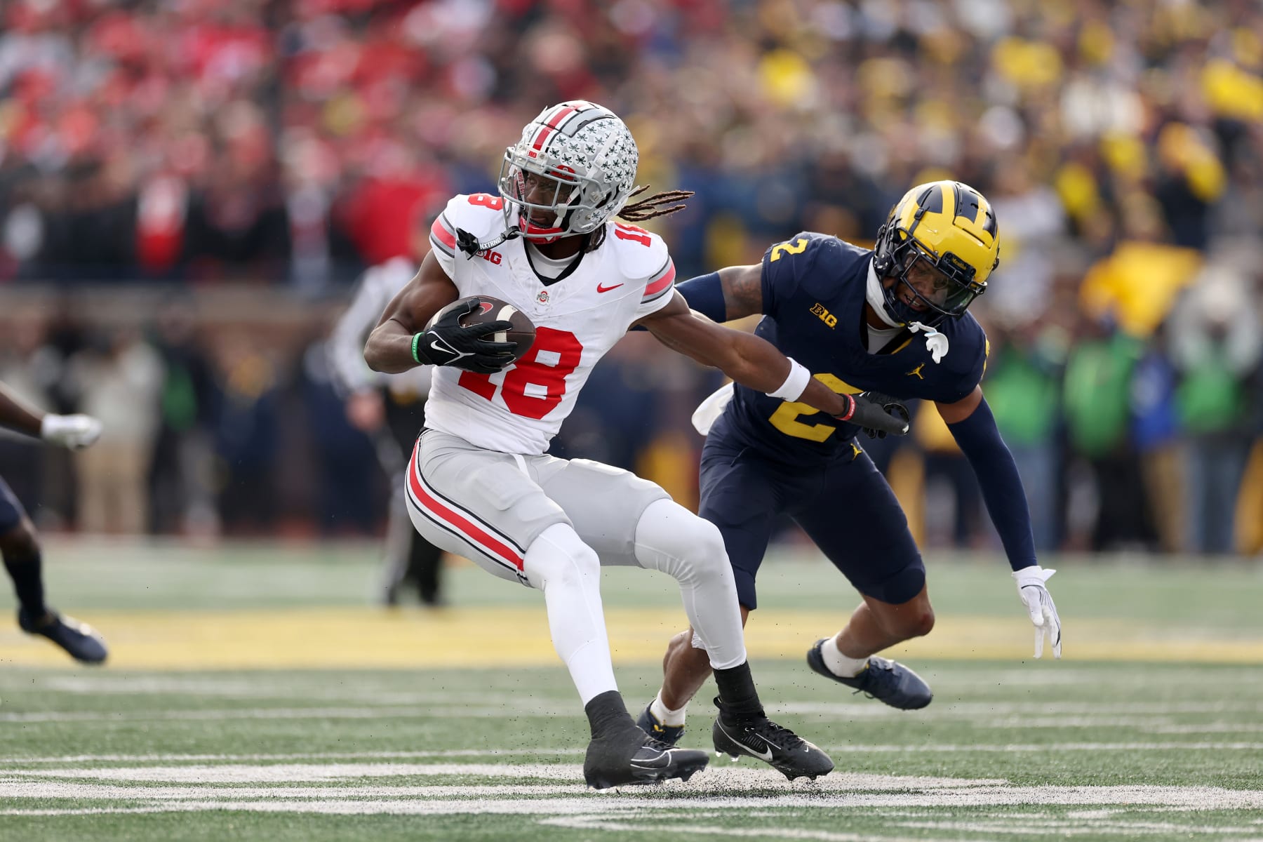 ANN ARBOR, MICHIGAN - NOVEMBER 25: Marvin Harrison Jr. #18 of the Ohio State Buckeyes makes a catch against Will Johnson #2 of the Michigan Wolverines during the third quarter in the game at Michigan Stadium on November 25, 2023 in Ann Arbor, Michigan. (Photo by Ezra Shaw/Getty Images)