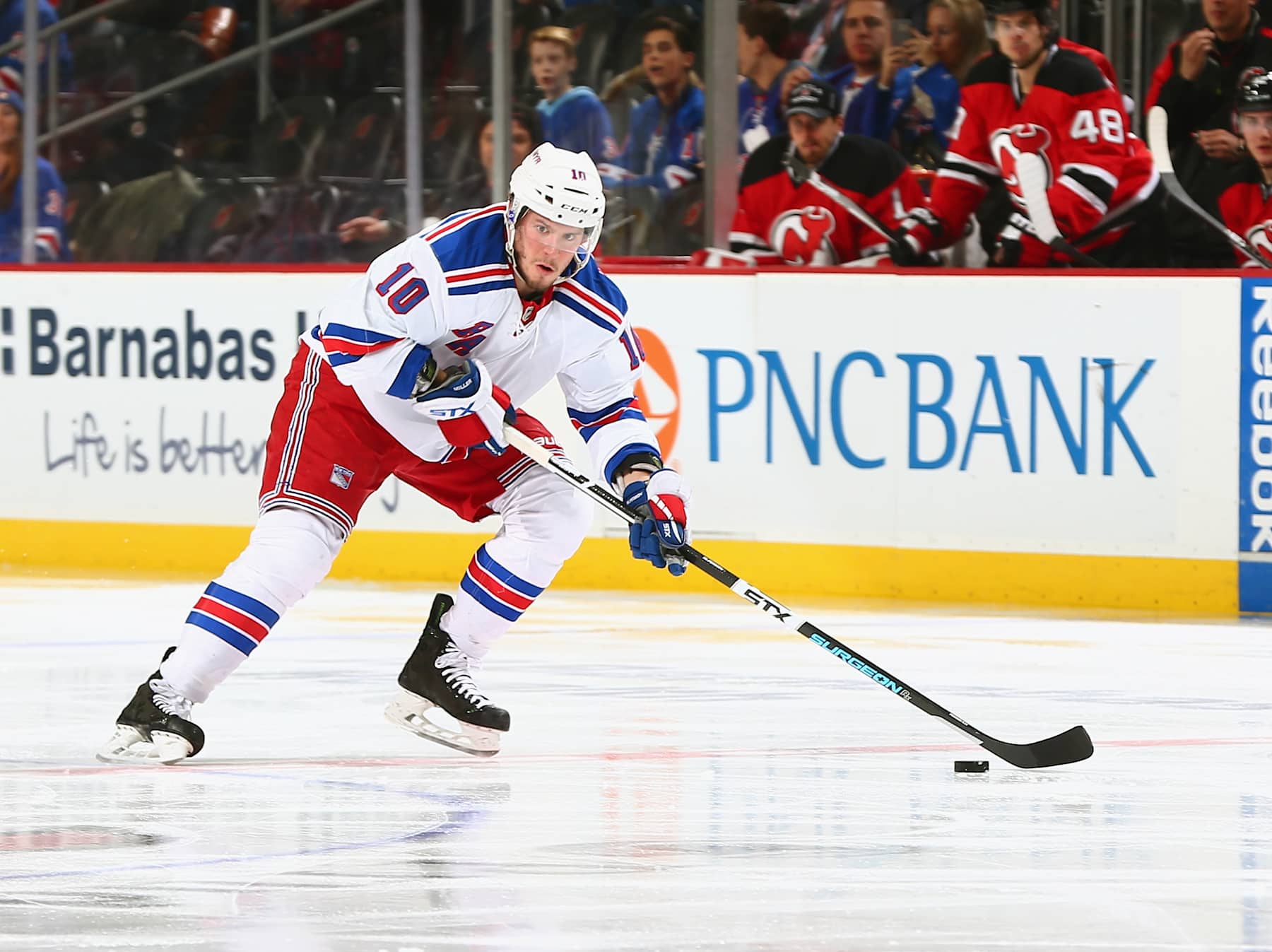 NEWARK, NJ - FEBRUARY 23: J.T. Miller #10 of the New York Rangers plays the puck during the game against the New Jersey Devils at the Prudential Center on February 23, 2016 in Newark, New Jersey. (Photo by Andy Marlin/NHLI via Getty Images)