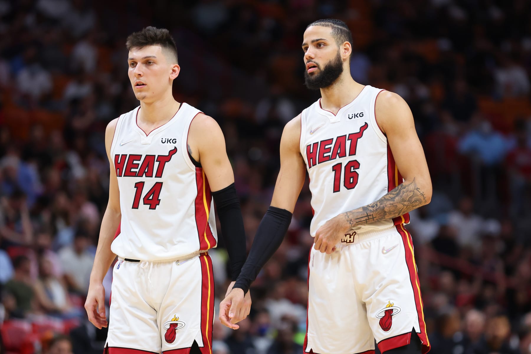MIAMI, FLORIDA - FEBRUARY 28: Tyler Herro #14 and Caleb Martin #16 of the Miami Heat look on against the Chicago Bulls at FTX Arena on February 28, 2022 in Miami, Florida. NOTE TO USER: User expressly acknowledges and agrees that, by downloading and or using this photograph, User is consenting to the terms and conditions of the Getty Images License Agreement.  (Photo by Michael Reaves/Getty Images)