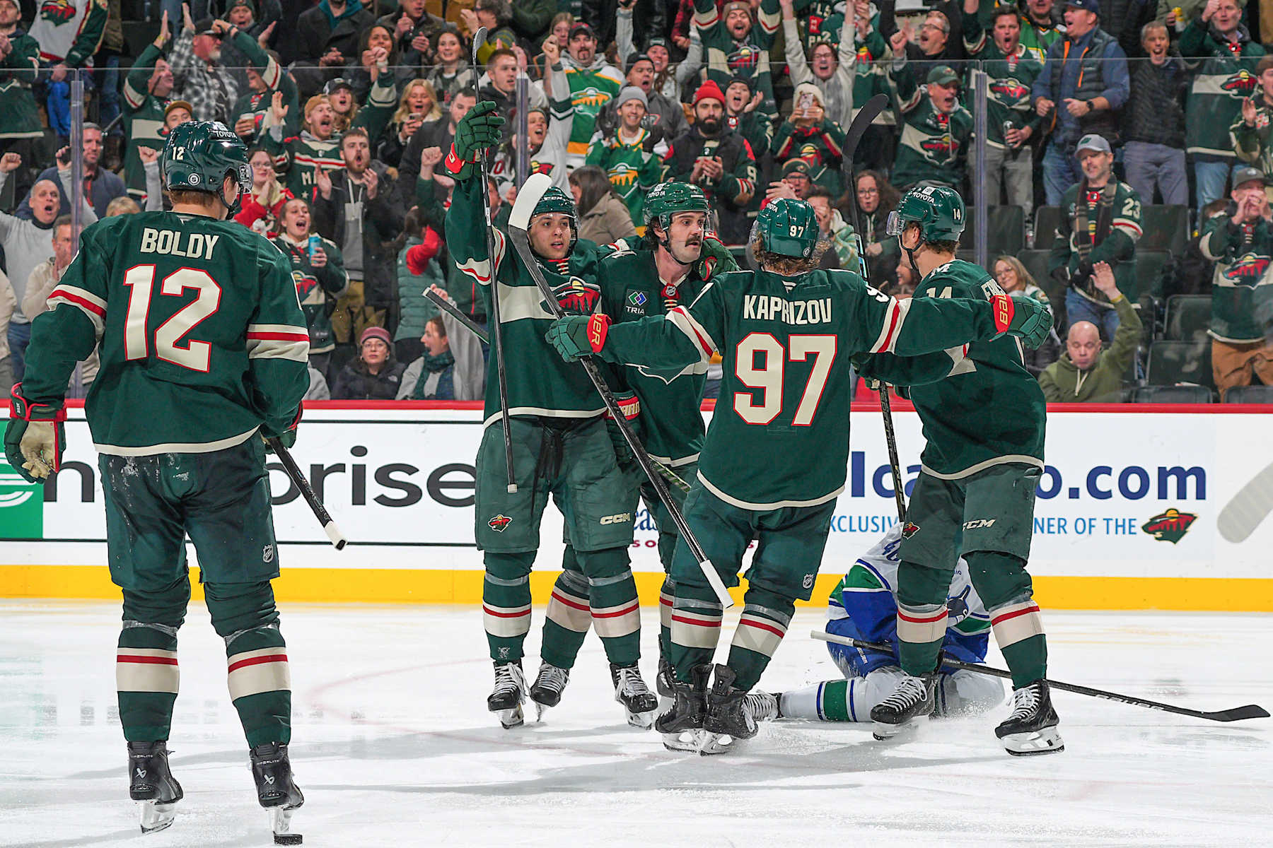 SAINT PAUL, MN - DECEMBER 3: Jake Middleton #5 celebrates his goal with his teammates Brock Faber #7, Kirill Kaprizov #97, Joel Eriksson Ek #14 and Matt Boldy #12 of the Minnesota Wild against the Vancouver Canucks during the game at the Xcel Energy Center on December 3, 2024 in Saint Paul, Minnesota. (Photo by Bruce Kluckhohn/NHLI via Getty Images)