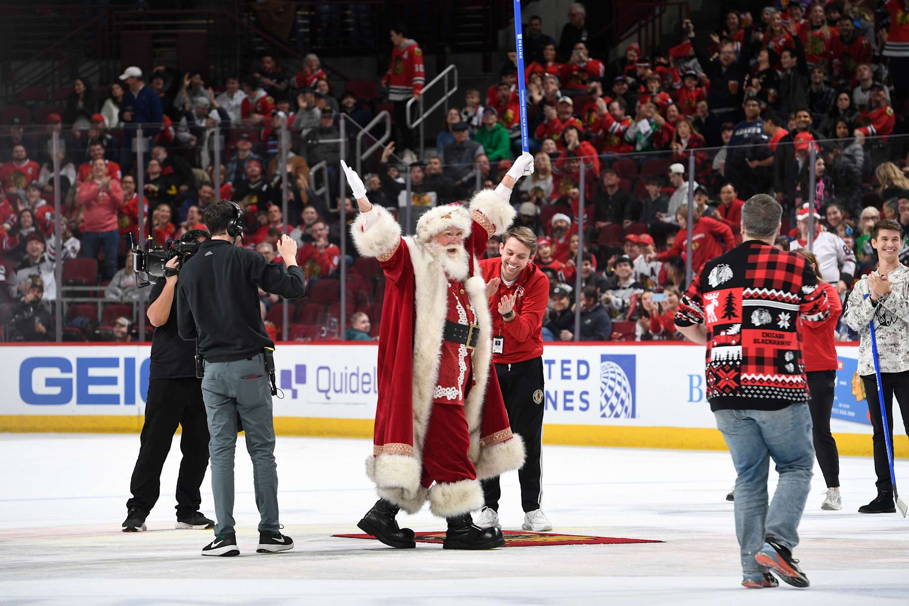 CHICAGO, ILLINOIS - DECEMBER 22: "Santa" reacts after shooting the puck in between periods of the game between the Chicago Blackhawks and the Montreal Canadiens at the United Center on December 22, 2023 in Chicago, Illinois. (Photo by Bill Smith/NHLI via Getty Images)