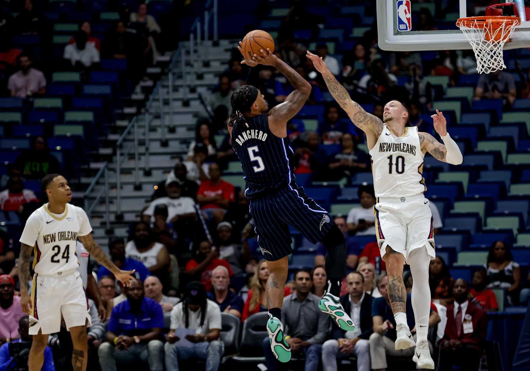 NEW ORLEANS, LOUISIANA - OCTOBER 7:  Paolo Banchero #5 of the Orlando Magic shoots over Daniel Theis #10 of the New Orleans Pelicans during the first half of a preseason game at the Smoothie King Center on October 7, 2024 in New Orleans, Louisiana. NOTE TO USER: User expressly acknowledges and agrees that, by downloading and or using this photograph, User is consenting to the terms and conditions of the Getty Images License Agreement. (Photo by Derick E. Hingle/Getty Images)