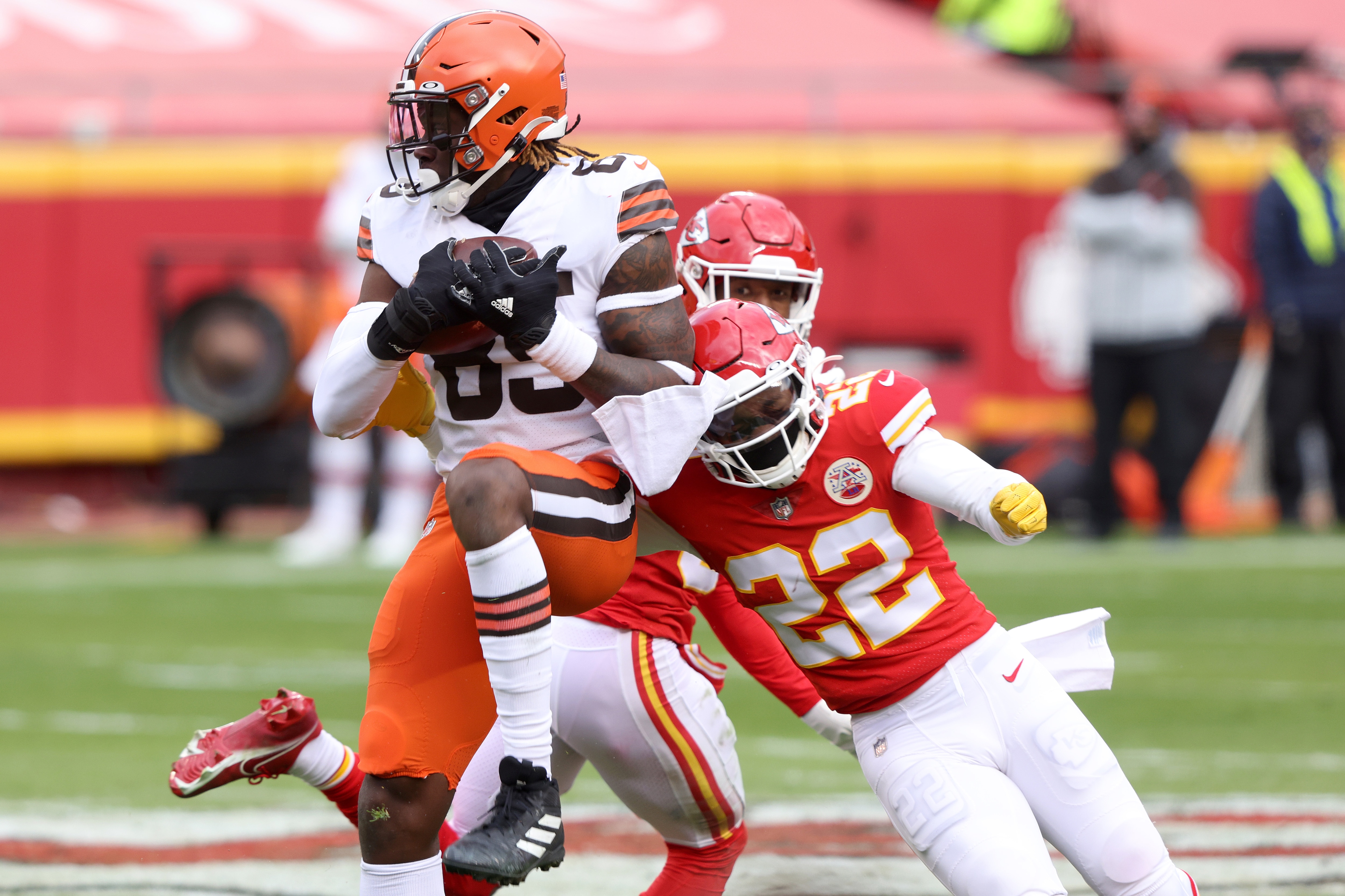 KANSAS CITY, MISSOURI - JANUARY 17: Tight end David Njoku #85 of the Cleveland Browns leaps over cornerback L'Jarius Sneed #38 and free safety Juan Thornhill #22 of the Kansas City Chief during the second quarter of the AFC Divisional Playoff game at Arrowhead Stadium on January 17, 2021 in Kansas City, Missouri. (Photo by Jamie Squire/Getty Images)