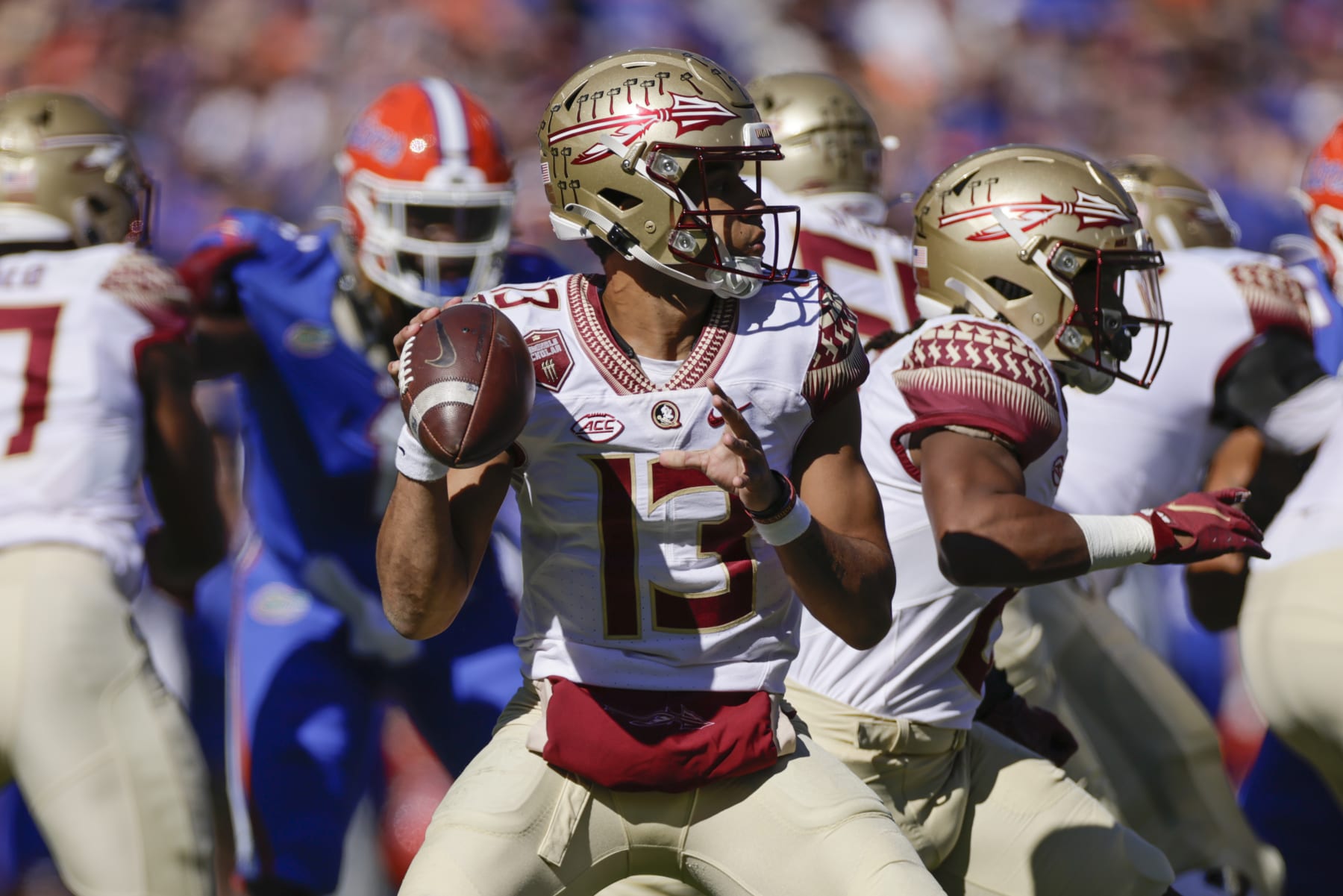 GAINESVILLE, FL - NOVEMBER 27: Florida State Seminoles quarterback Jordan Travis (13) throws a pass during the game between the Florida State Seminoles and the Florida Gators on November 27, 2021 at Ben Hill Griffin Stadium in Gainesville, Fl. (Photo by David Rosenblum/Icon Sportswire via Getty Images)