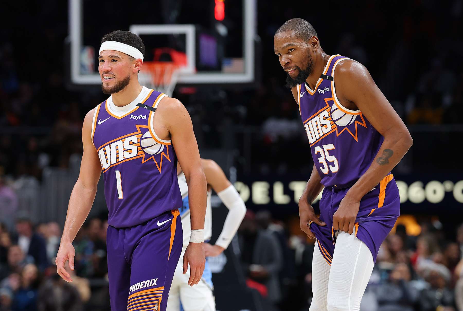 ATLANTA, GEORGIA - JANUARY 14:  Devin Booker #1 and Kevin Durant #35 of the Phoenix Suns reacts against the Atlanta Hawks during the third quarter at State Farm Arena on January 14, 2025 in Atlanta, Georgia.  NOTE TO USER: User expressly acknowledges and agrees that, by downloading and/or using this photograph, user is consenting to the terms and conditions of the Getty Images License Agreement.  (Photo by Kevin C. Cox/Getty Images)