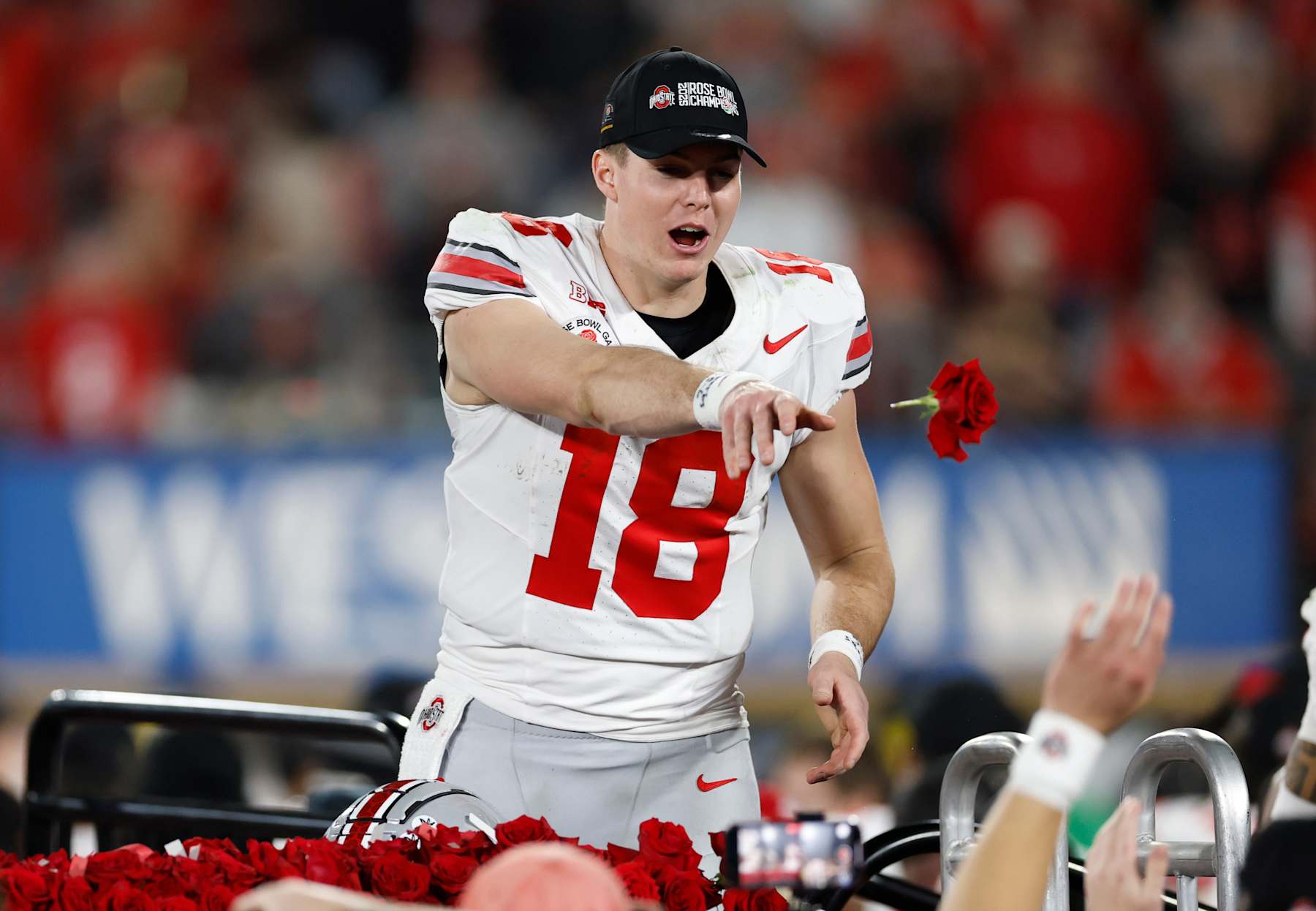 PASADENA, CALIFORNIA - JANUARY 01: Will Howard #18 of the Ohio State Buckeyes tosses a rose after defeating the Oregon Ducks 41-21 in the Rose Bowl Game Presented by Prudential at Rose Bowl Stadium on January 01, 2025 in Pasadena, California. (Photo by Ronald Martinez/Getty Images)