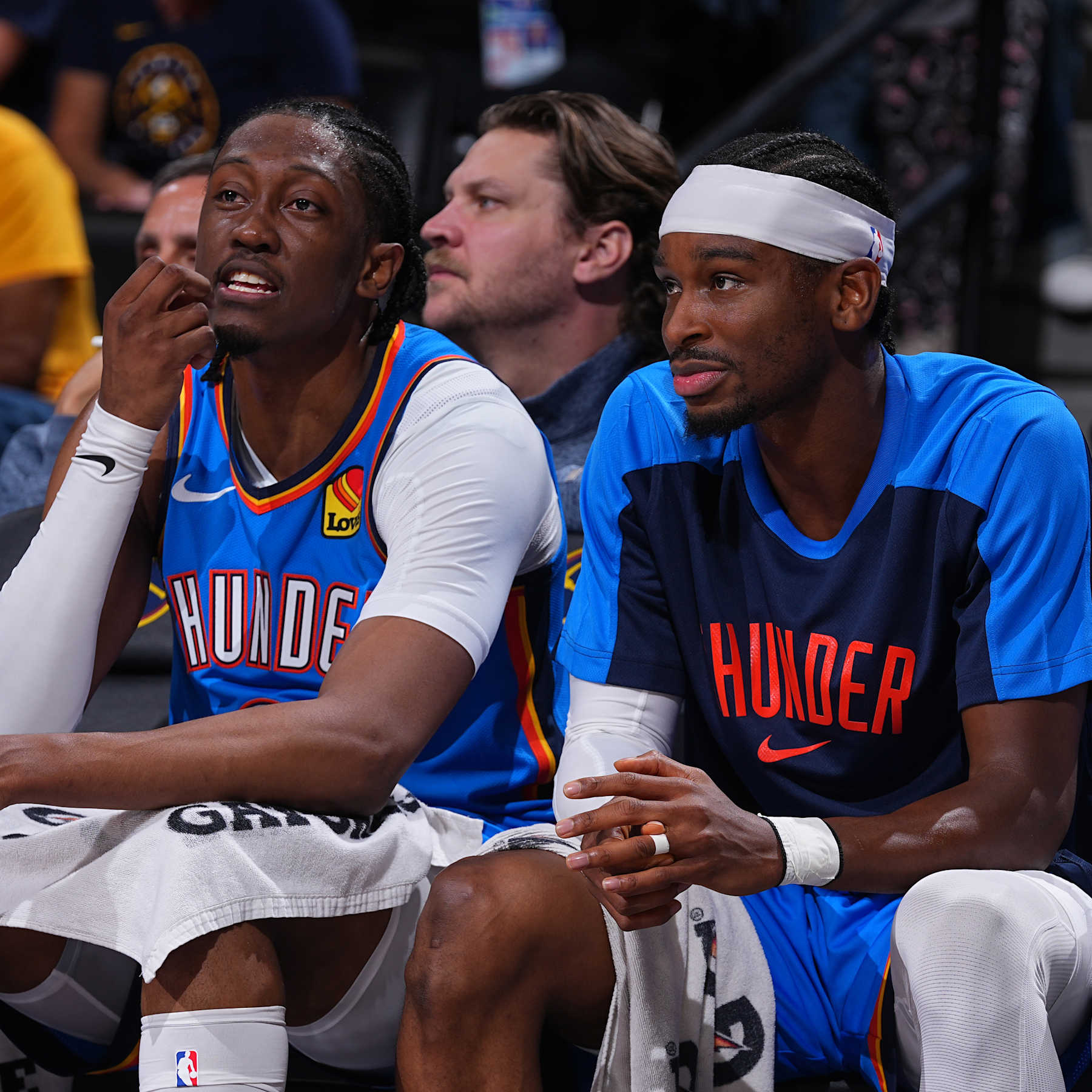 DENVER, CO - OCTOBER 15: Jalen Williams #8 and Shai Gilgeous-Alexander #2 of the Oklahoma City Thunder look on during the game against the Denver Nuggets during a NBA pre season game on October 15, 2024 at Ball Arena in Denver, Colorado. NOTE TO USER: User expressly acknowledges and agrees that, by downloading and/or using this Photograph, user is consenting to the terms and conditions of the Getty Images License Agreement. Mandatory Copyright Notice: Copyright 2024 NBAE (Photo by Bart Young/NBAE via Getty Images)