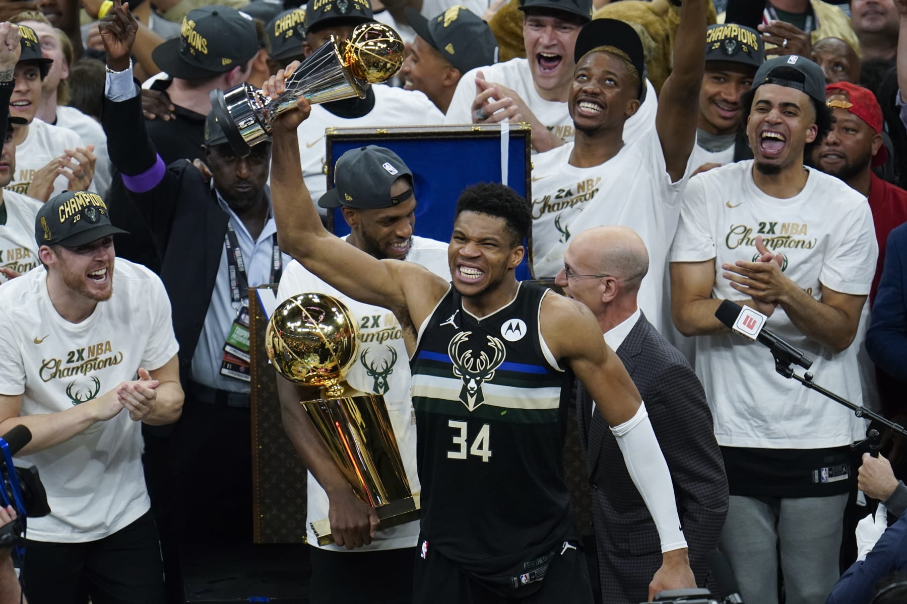 Milwaukee Bucks forward Giannis Antetokounmpo holds up the most valuable player trophy after Game 6 of basketball's NBA Finals against the Phoenix Suns in Milwaukee, Tuesday, July 20, 2021. (AP Photo/Paul Sancya)