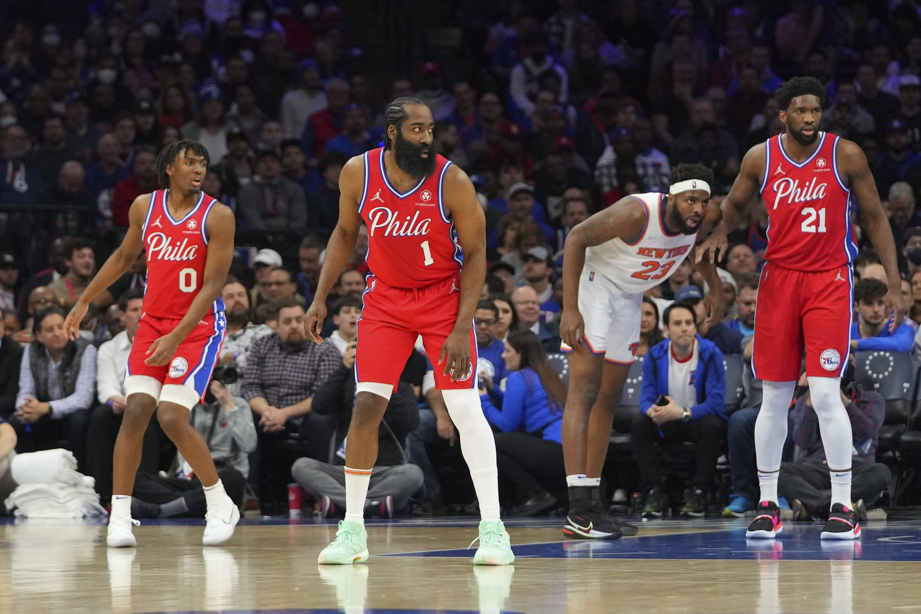 PHILADELPHIA, PA - MARCH 02: James Harden #1, Tyrese Maxey #0, and Joel Embiid #21 of the Philadelphia 76ers in action against Mitchell Robinson #23 of the New York Knicks at the Wells Fargo Center on March 2, 2022 in Philadelphia, Pennsylvania. The 76ers defeated the Knicks 123-108. NOTE TO USER: User expressly acknowledges and agrees that, by downloading and or using this photograph, User is consenting to the terms and conditions of the Getty Images License Agreement. (Photo by Mitchell Leff/Getty Images)