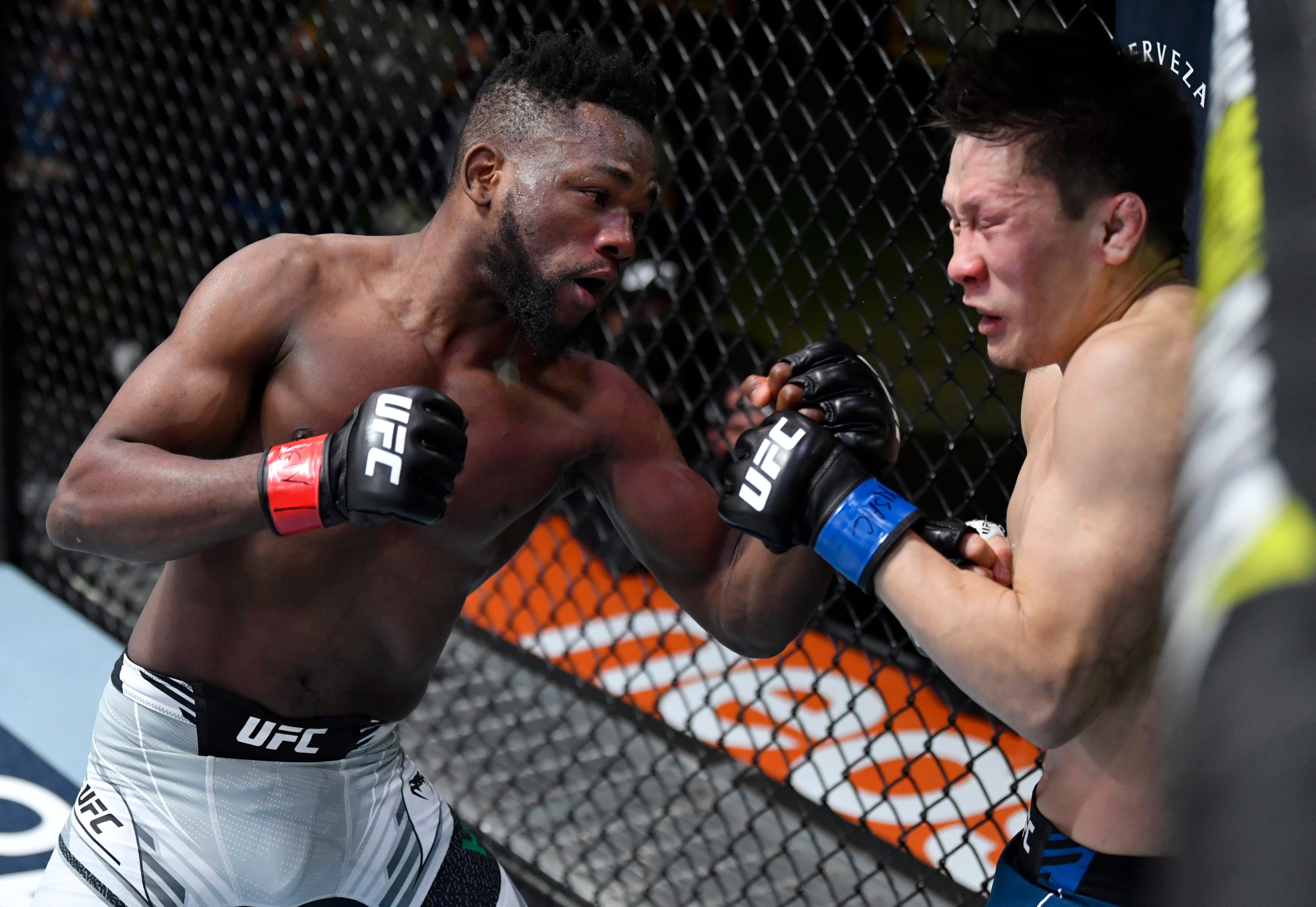 LAS VEGAS, NEVADA - DECEMBER 04: (L-R) Manel Kape of Angola punches Zhalgas Zhumagulov of Kazakhstan in their flyweight fight during the UFC Fight Night event at UFC APEX on December 04, 2021 in Las Vegas, Nevada. (Photo by Jeff Bottari/Zuffa LLC)