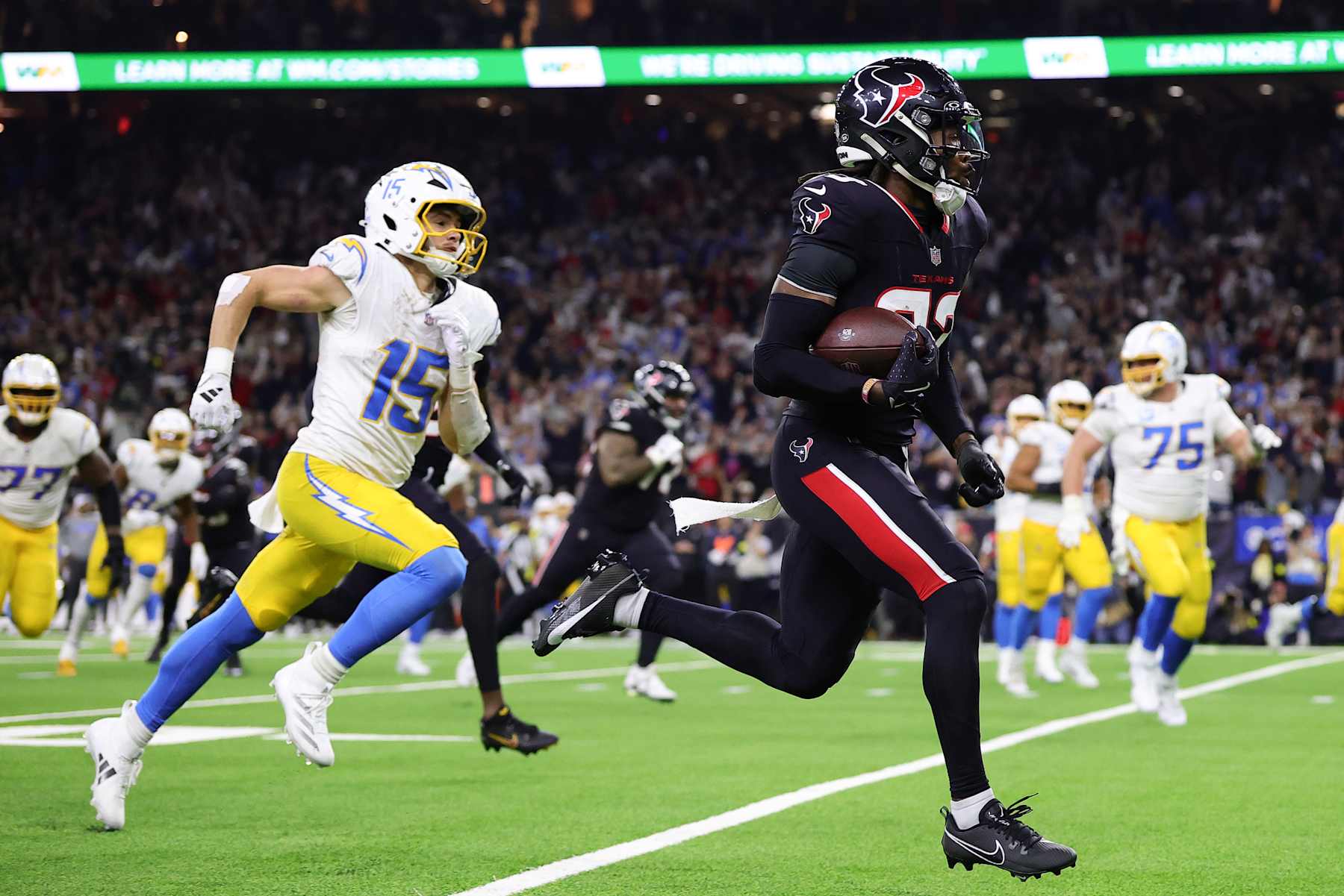 Houston Texans defensive back Eric Murray runs for a touchdown after an interception against the Los Angeles Chargers. 