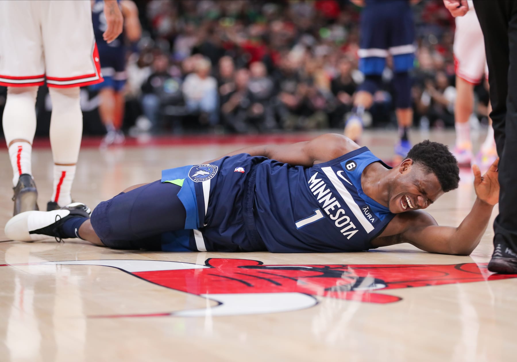 CHICAGO, IL - MARCH 17: Minnesota Timberwolves guard Anthony Edwards (1) grabs his ankle on the court during a NBA game between the Minnesota Timberwolves and the Chicago Bulls on March 17, 2023 at the United Center in Chicago, IL. (Photo by Melissa Tamez/Icon Sportswire via Getty Images)