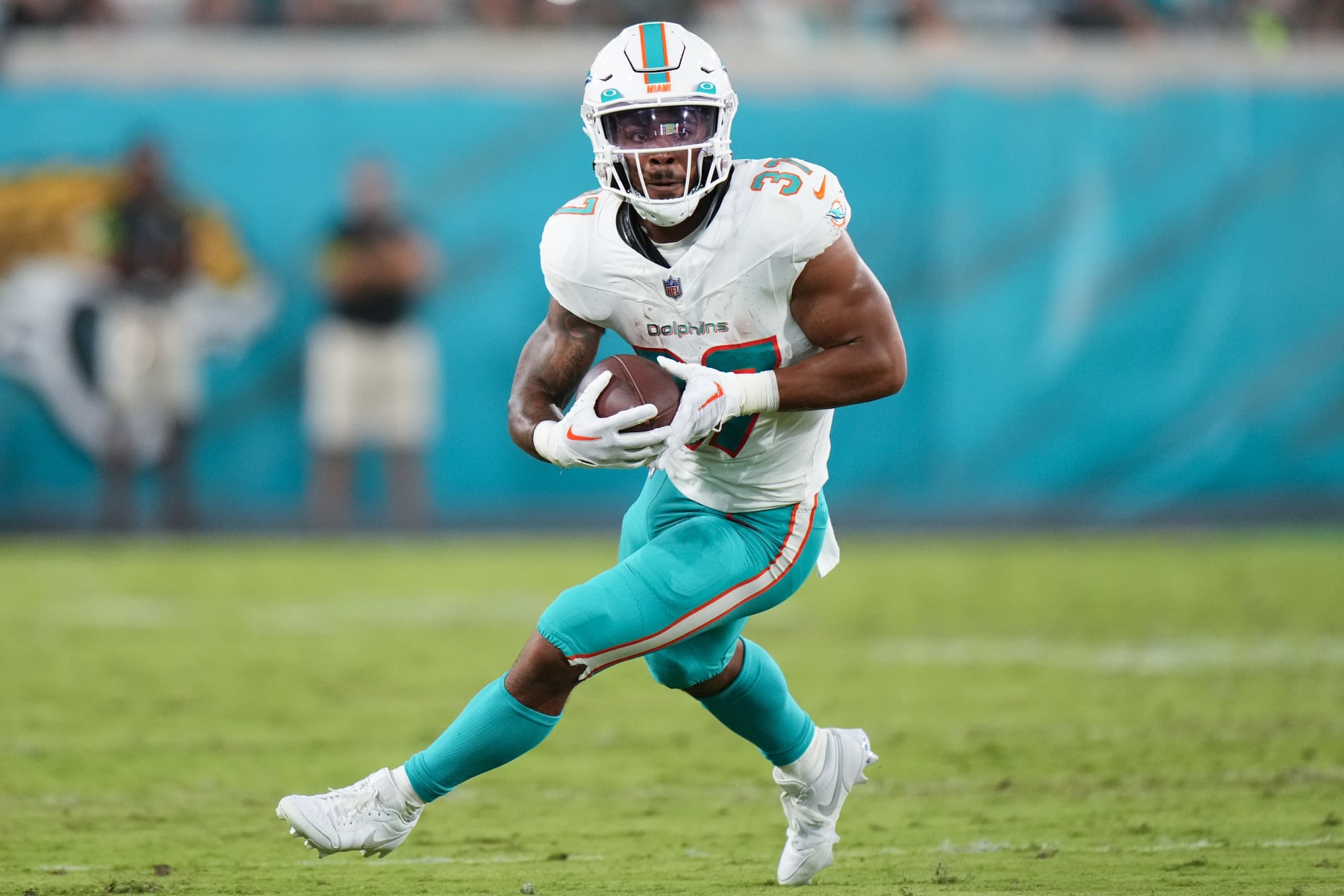 JACKSONVILLE, FLORIDA - AUGUST 26: Myles Gaskin #37 of the Miami Dolphins runs the ball against the Jacksonville Jaguars during the second half of a preseason game at TIAA Bank Field on August 26, 2023 in Jacksonville, Florida. (Photo by Rich Storry/Getty Images)