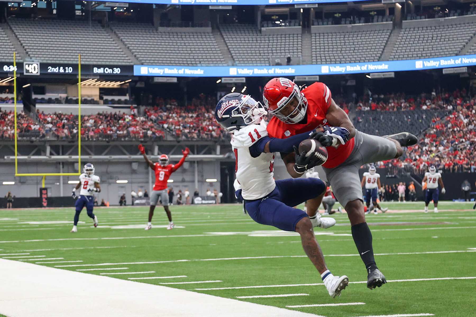 LAS VEGAS, NEVADA - SEPTEMBER 28: Jalen Catalon #1 of the UNLV Rebels intercepts a pass intended for Raylen Sharpe #11 of the Fresno State Bulldogs during the second quarter of a game at Allegiant Stadium on September 28, 2024 in Las Vegas, Nevada.  (Photo by Ian Maule/Getty Images)