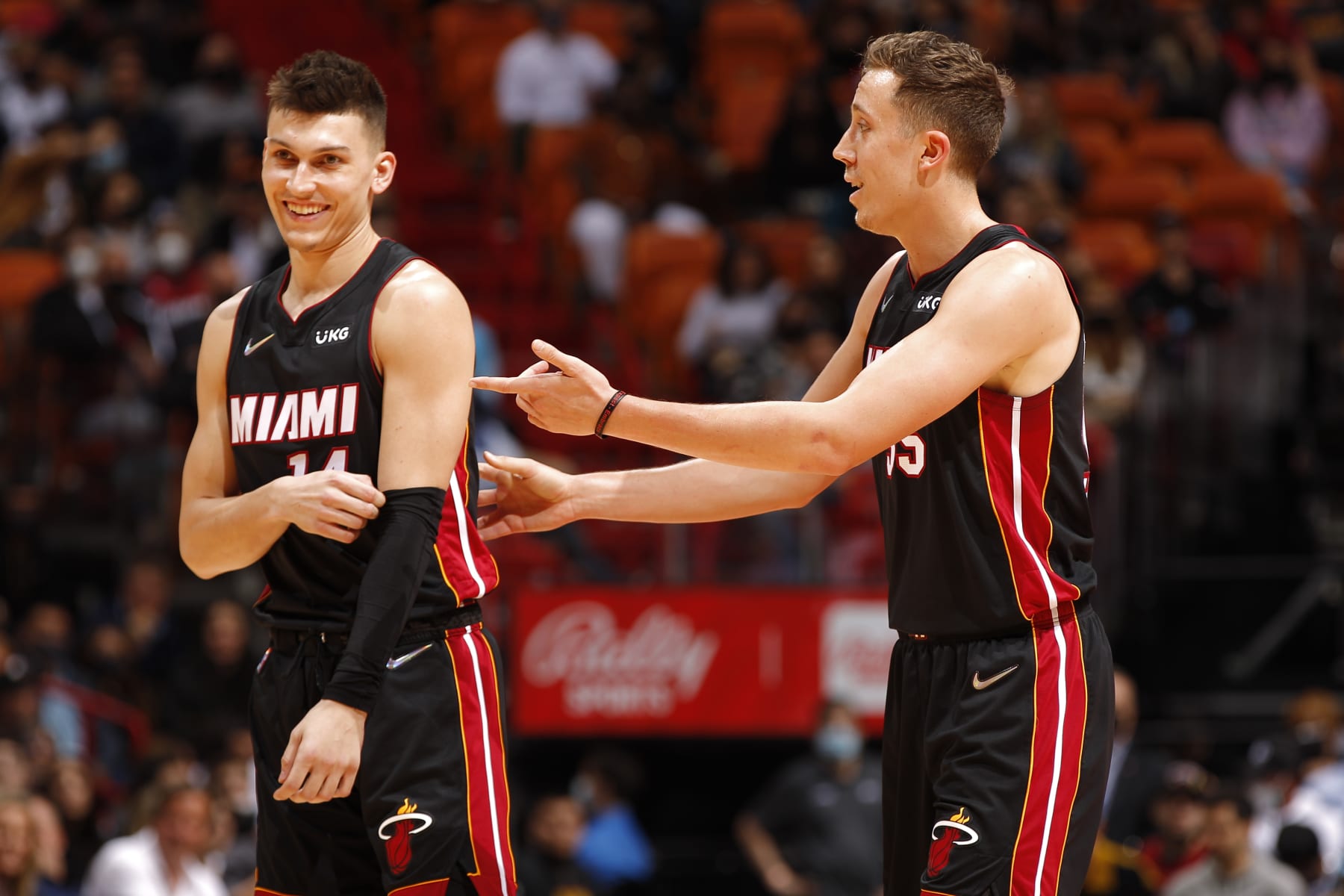 MIAMI, FL - JANUARY 17: Tyler Herro #14 talks to Duncan Robinson #55 of the Miami Heat during the game against the Toronto Raptors on January 17, 2022 at FTX Arena in Miami, Florida. NOTE TO USER: User expressly acknowledges and agrees that, by downloading and or using this Photograph, user is consenting to the terms and conditions of the Getty Images License Agreement. Mandatory Copyright Notice: Copyright 2022 NBAE (Photo by Issac Baldizon/NBAE via Getty Images)